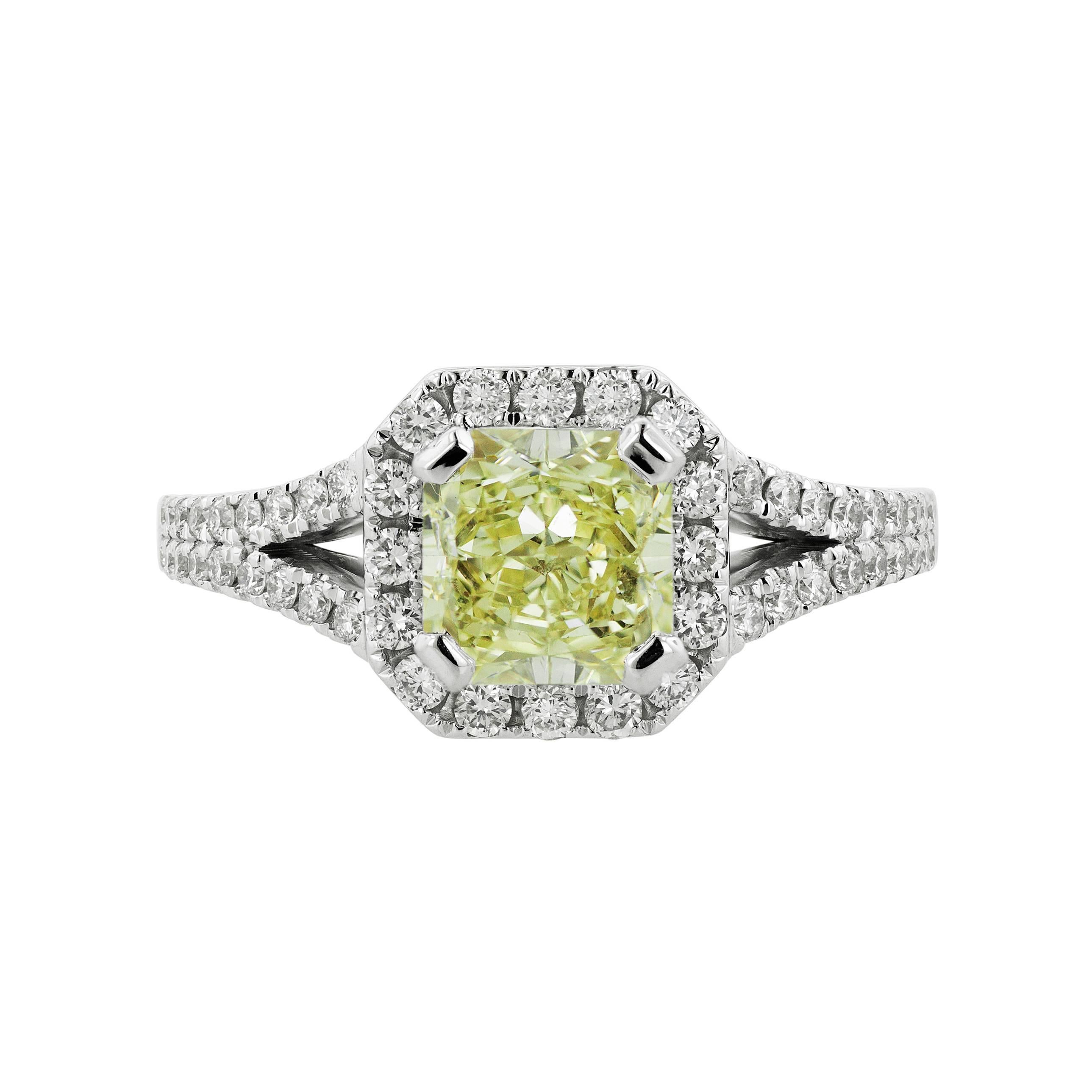 A classic and elegant split shank halo ring by Tears Undressed. A hand-made new jewelry piece set in 18 karat white gold with an exceptional 1.61 carat yellow (W-X) center stone. Encircled by a halo of 52 white round diamonds, creating a surface of