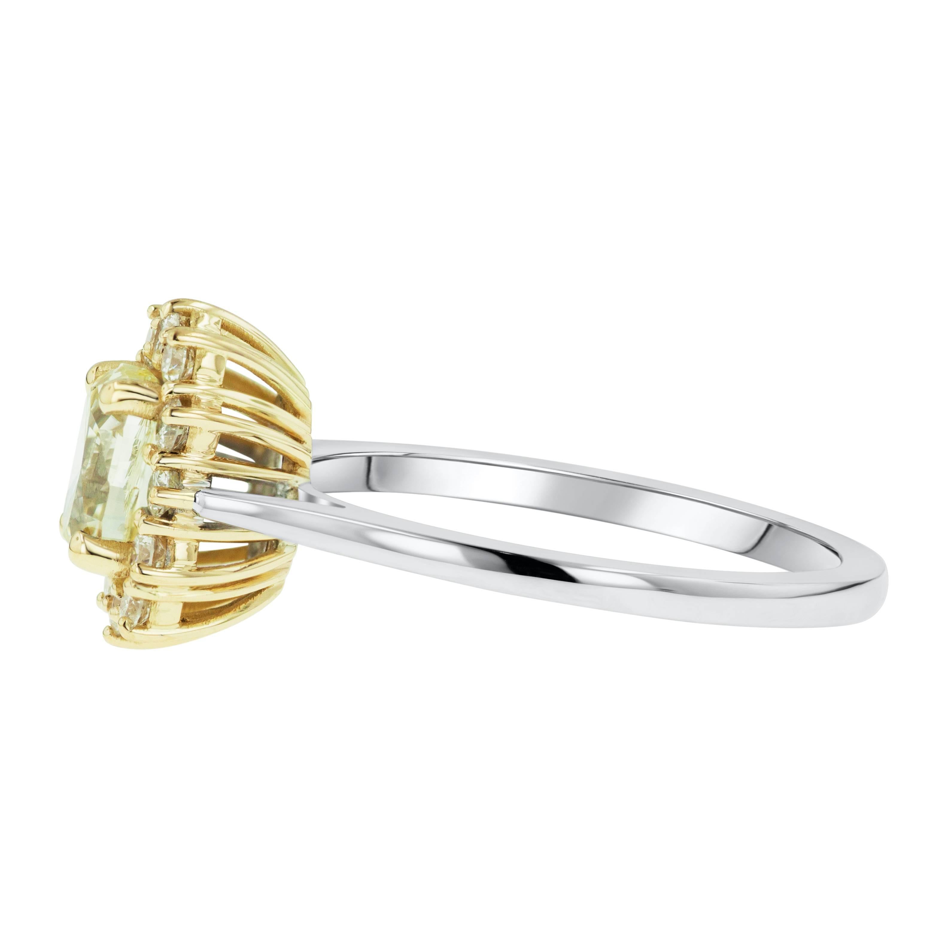 Beautiful Belle Époque inspired ring by Tears Undressed. This hand-made new jewelry piece is set in 14 karat white gold with an 18 karat yellow gold basket. The center stone is an exceptional 1.00 carat Fancy Yellow oval diamond encircled by 12