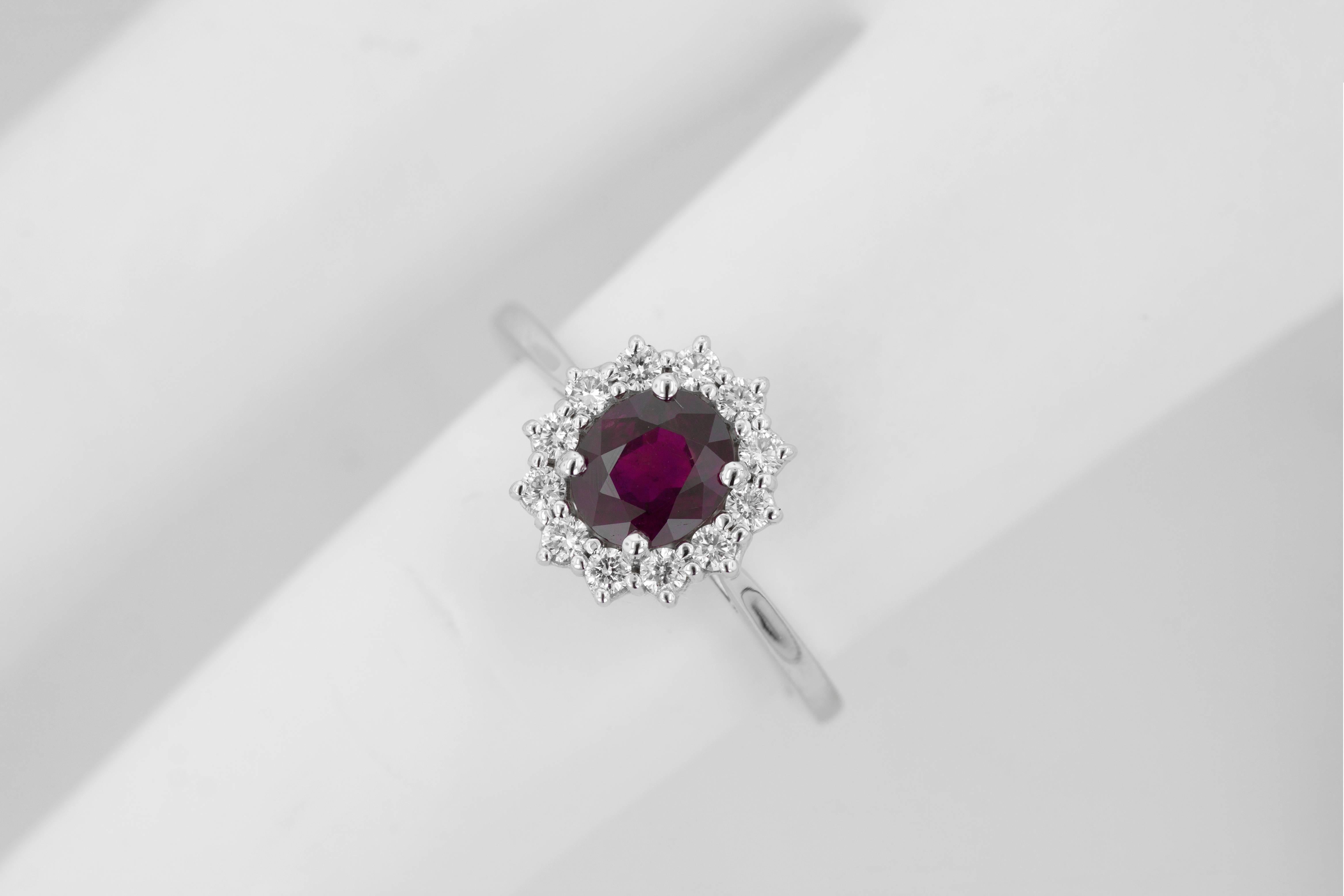 Beautiful Belle Époque inspired ruby & diamond ring by Tears Undressed. This 14 karat white gold hand-made new engagement ring is set with an 1.05ct oval ruby center stone encircled by a beautiful halo of 12 white round diamonds. The ring is a