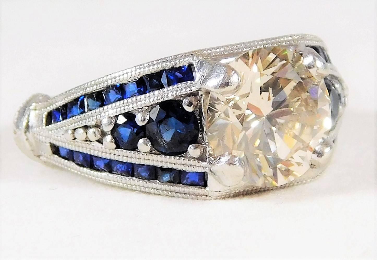 

From an exclusive estate.   This exotic ring is perfect for someone who is looking for something unique. This custom-made platinum diamond ring is one of a kind. Its platinum setting is jeweled with 4 round sapphires and 28 princess cut sapphires