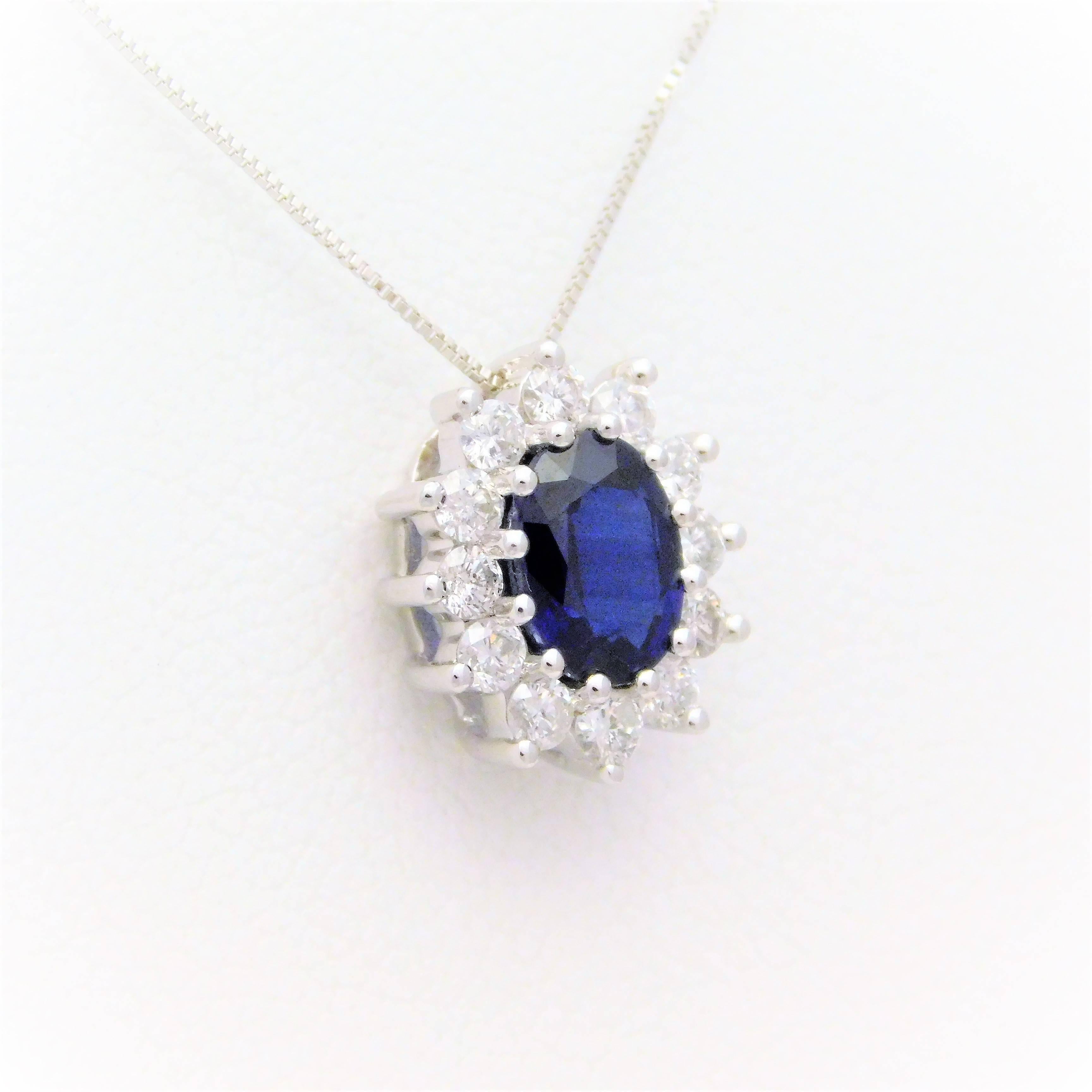 From a noble New Orleans estate, this exquisite pendant necklace has been crafted in solid 14k white gold.  It has been masterfully jeweled with a gorgeous deep blue oval faceted natural sapphire totaling 0.90ct.  Surrounding this amazing stone, in