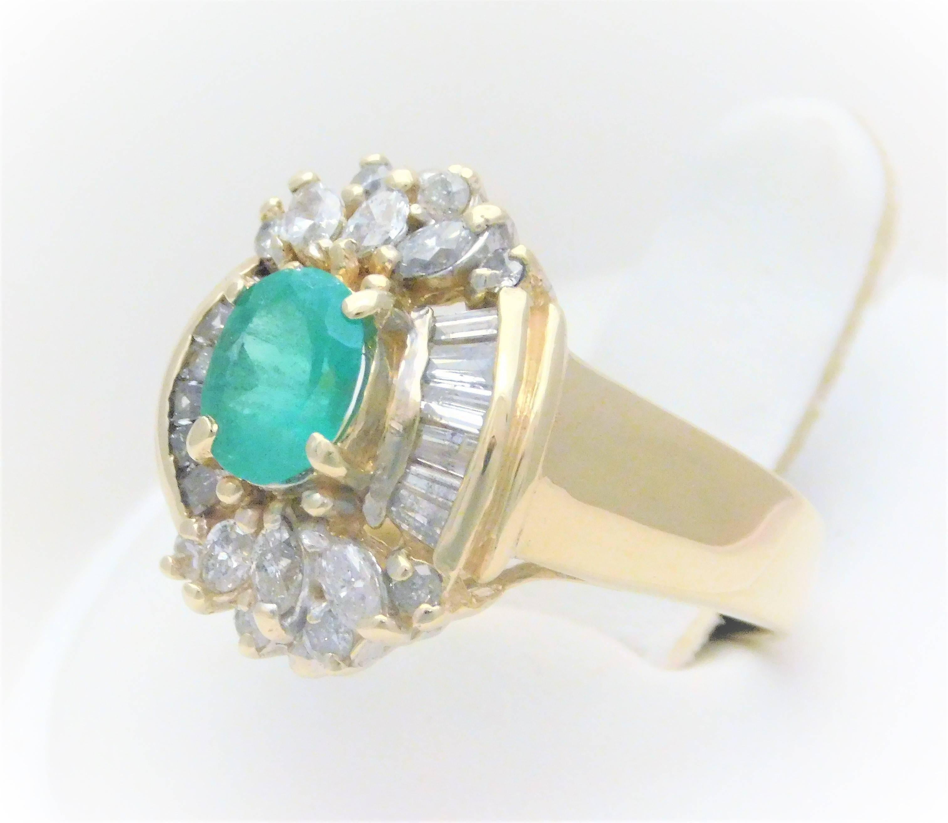 From a noble New Orleans estate.  Circa 1940-1950.  This exquisite ring has been hand crafted in solid 14k yellow gold with a polished finish.  It features a beautiful green oval faceted natural emerald approximating 1ct in weight.  Flanking this