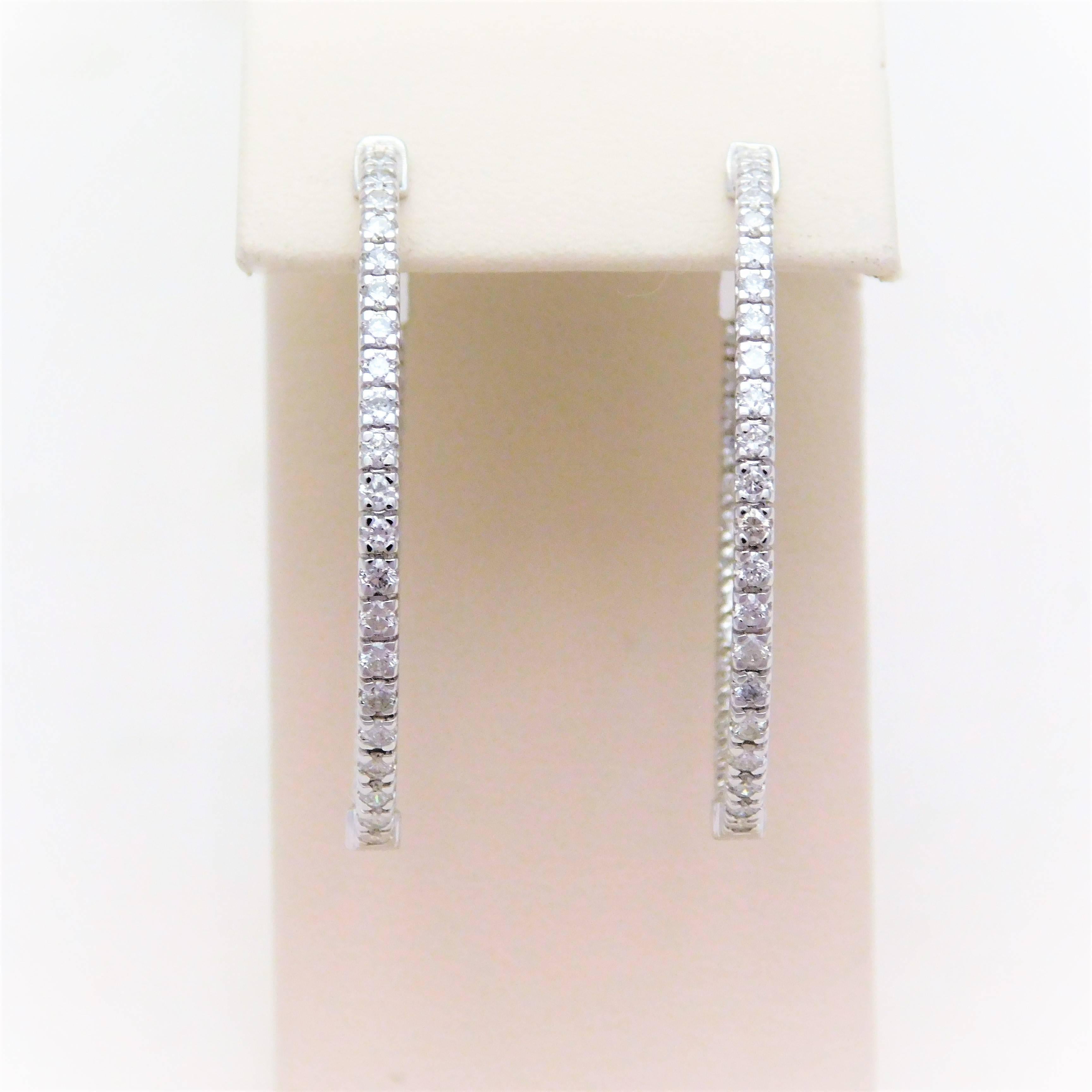 

Hand crafted by one of our master jewelers.  Circa 2017.  This gorgeous set of diamond hoop earrings have been hand crafted in solid 14k white gold.  They are masterfully jeweled with 74 bright and sparkling round-brilliant cut diamonds totaling a