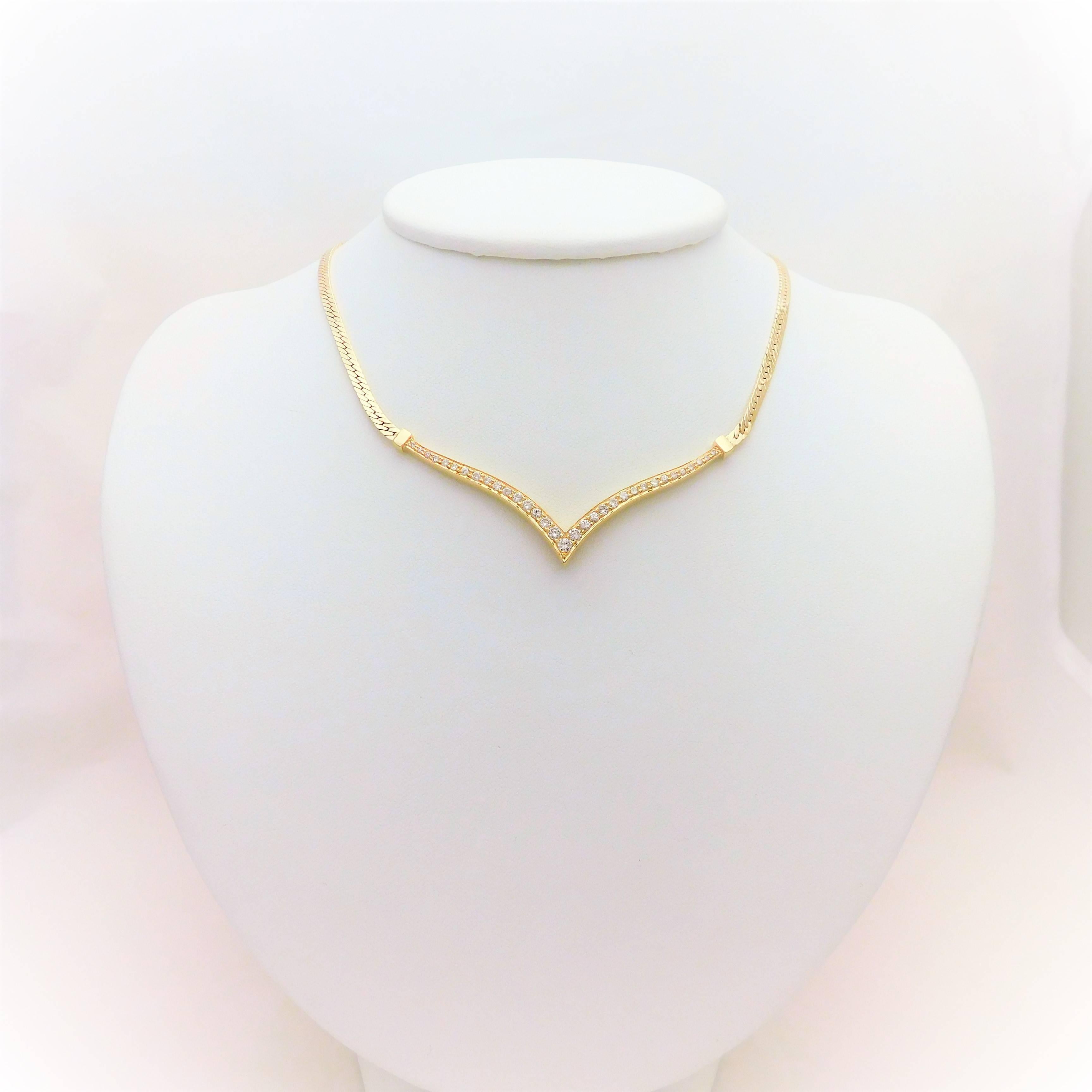 From a charming Southern estate. Circa 1960.  This breathtaking necklace has been crafted in solid 14k yellow gold. The gorgeous flat 3mm herringbone chain connects to a dazzling V shaped 14k gold pendant jeweled with 33 round brilliant-cut diamonds