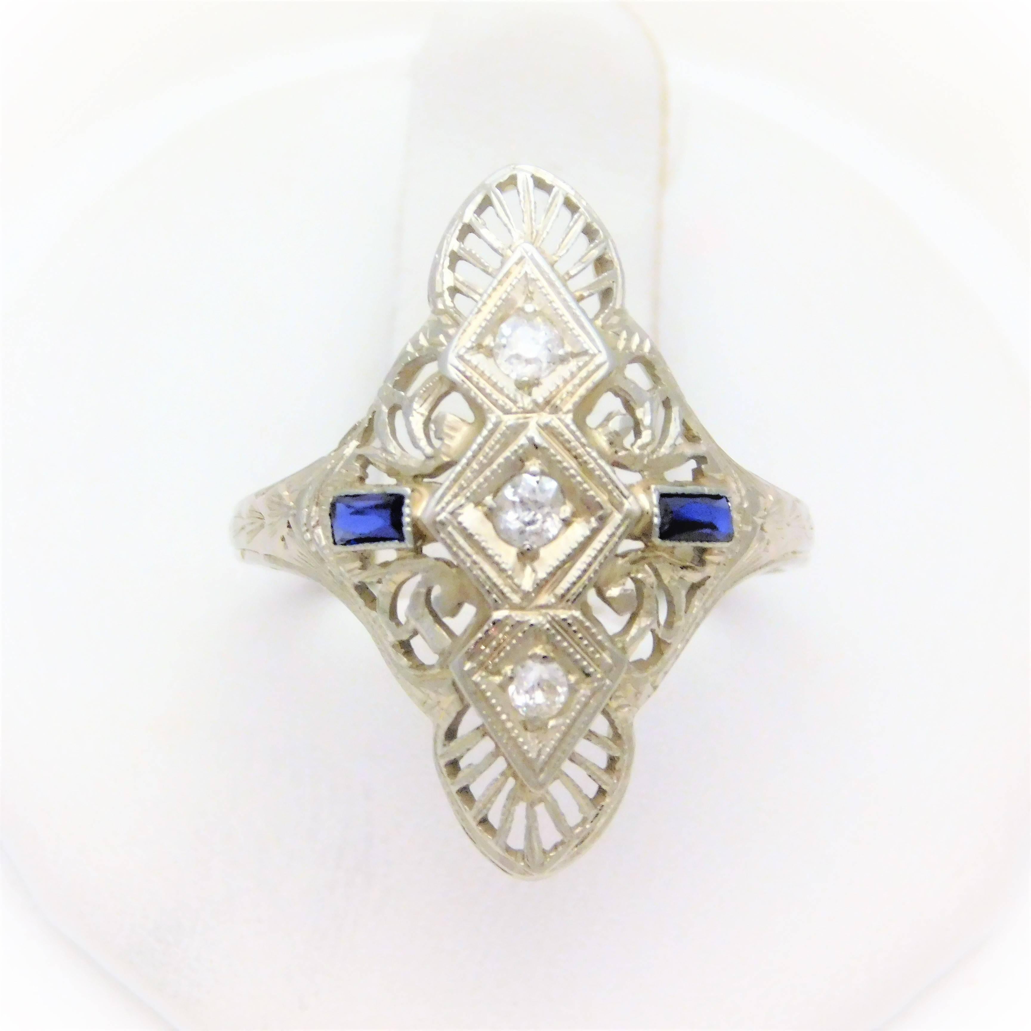 From a lovely New Orleans estate.  Circa Early 20th Century.  The shield ring design was one of the most popular designs from 1900-1930.  This beautiful example has been hand crafted in solid 18k white gold.  It has been masterfully jeweled with