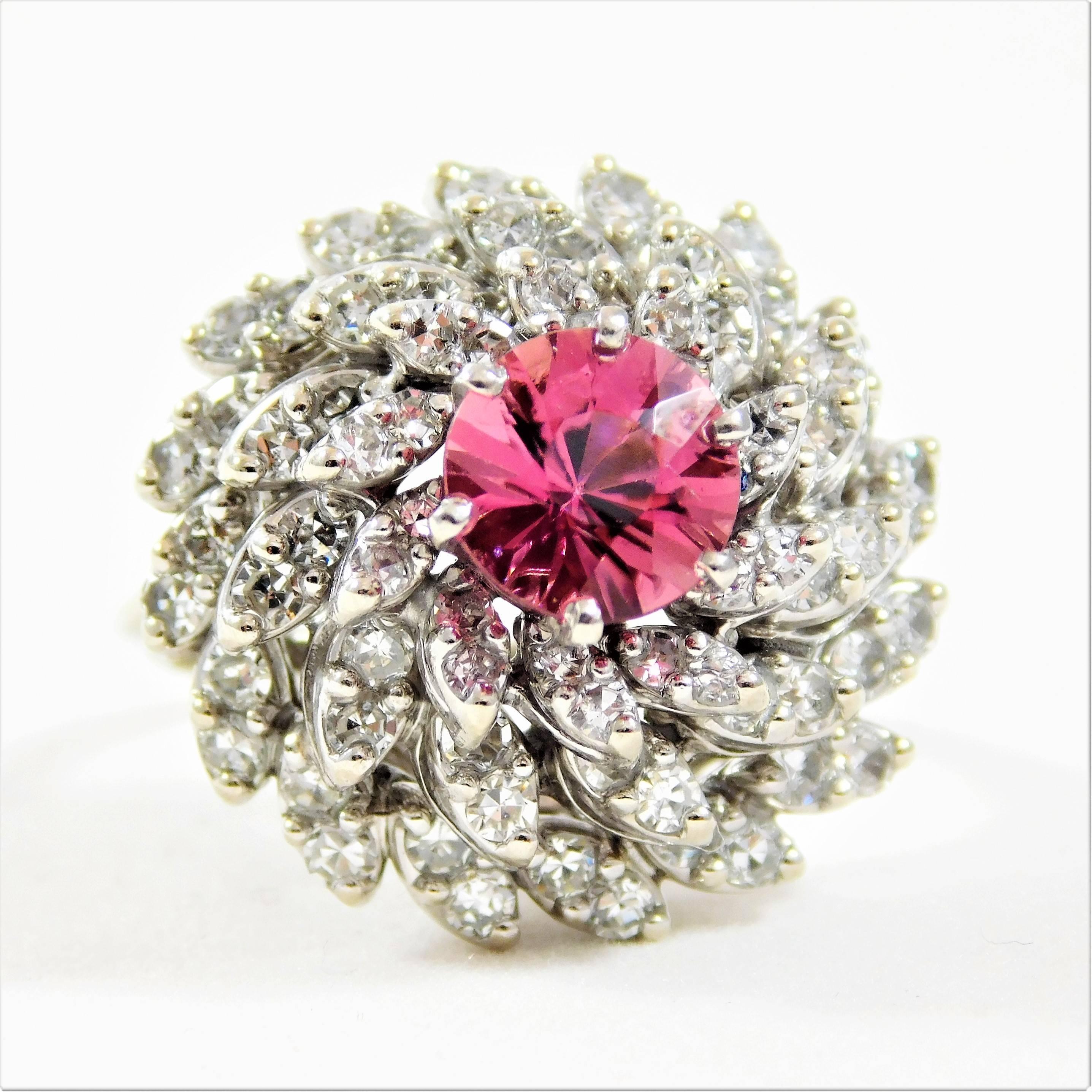 An estate piece. These astonishing ladies’ ring is made of solid 14k white gold.  It features a captivating 2.25ct round brilliant-cut pink sapphire as its center stone. The Pink Sapphire is a miracle of mother nature and is traditionally more