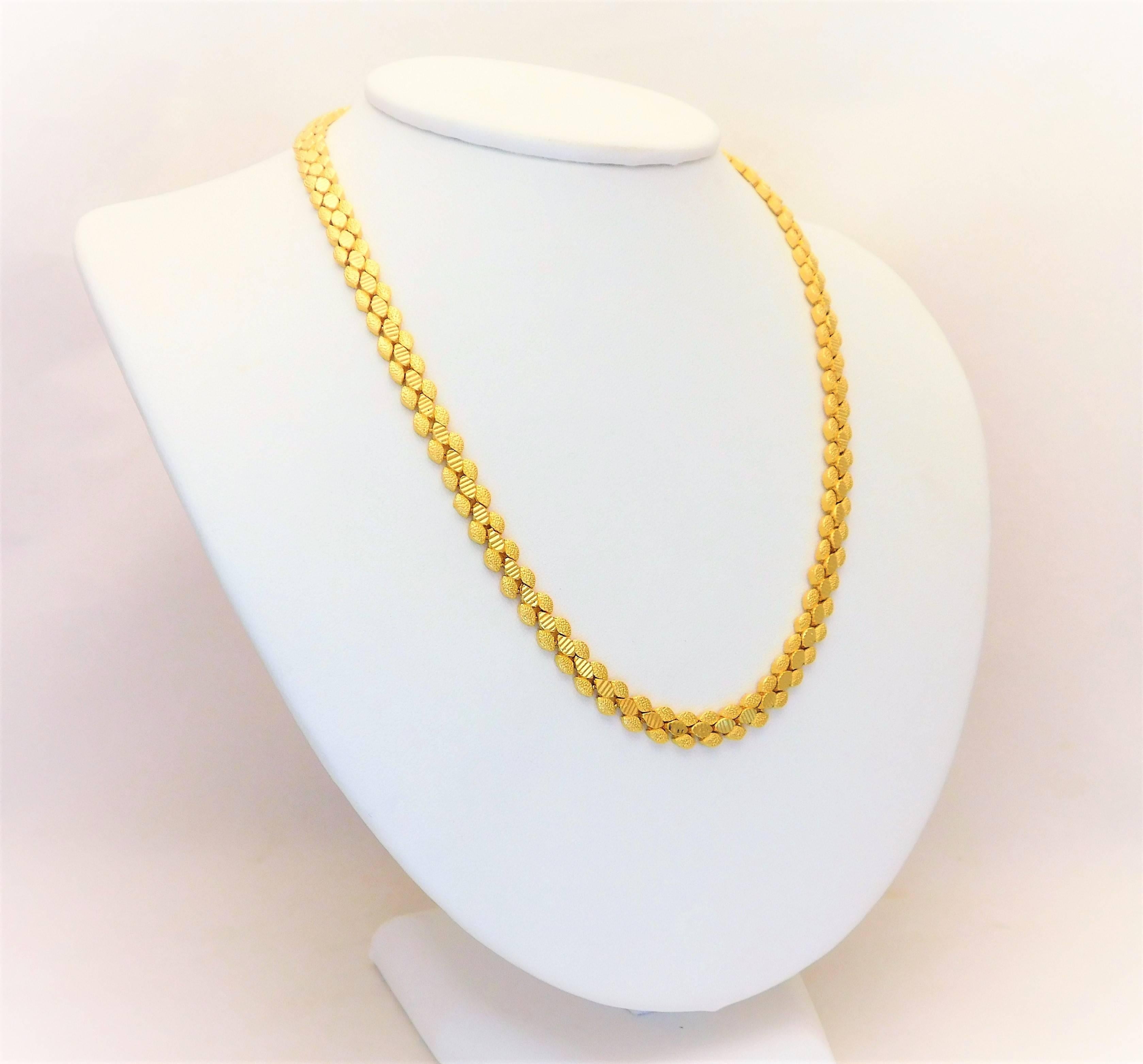 Circa 2000.   This gorgeous Mediterranean-style link necklace has been crafted in solid 14k yellow gold.  However, the bright and deep rich gold color gives the appearance of a 24k piece.  The time and effort put into the intricacy and detail of the