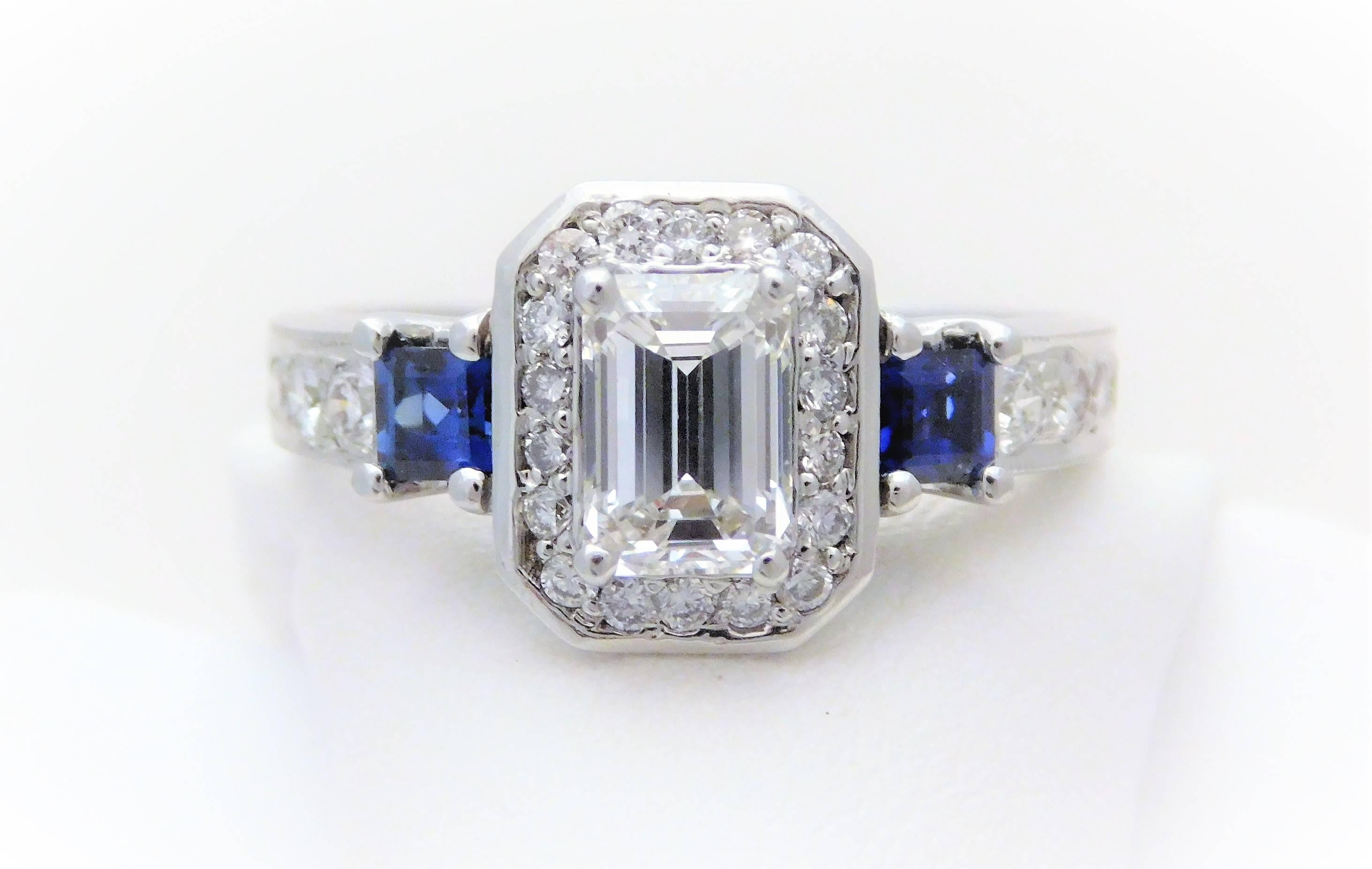 GIA Certified 14k Emerald-Cut Diamond and Ceylon Sapphire Engagement Ring  

From a stately New Orleans estate.  Circa 1970.  This exquisite ring has been hand crafted in solid 14k white gold.  It is masterfully jeweled with an opulent GIA certified