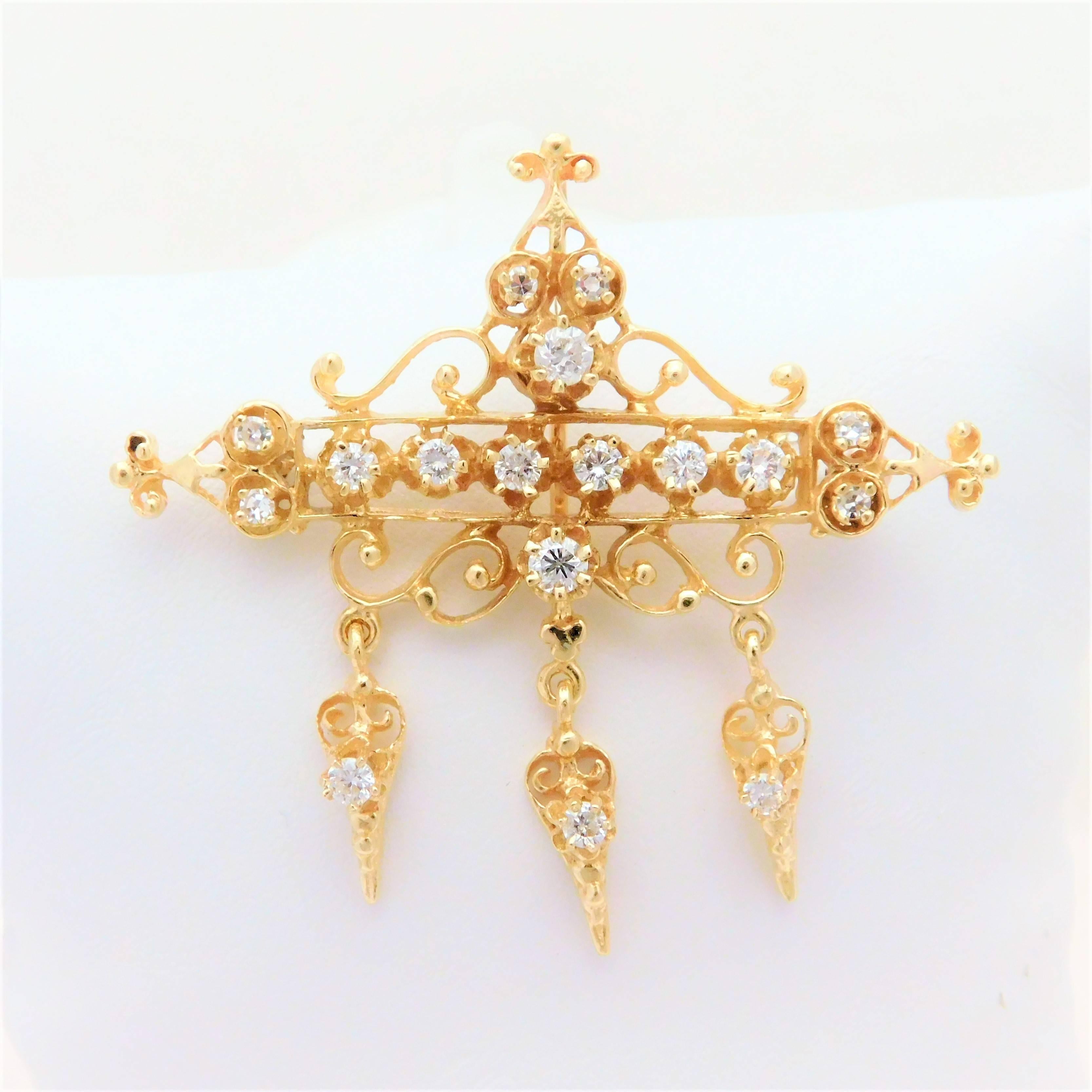 

An estate piece.  This ornate brooch has the ability to be worn as a pendant as well as a pin.  It is made of solid 14k yellow gold.  The intricate unique baroque style metal work as well as the bright dazzling stones make this piece a show