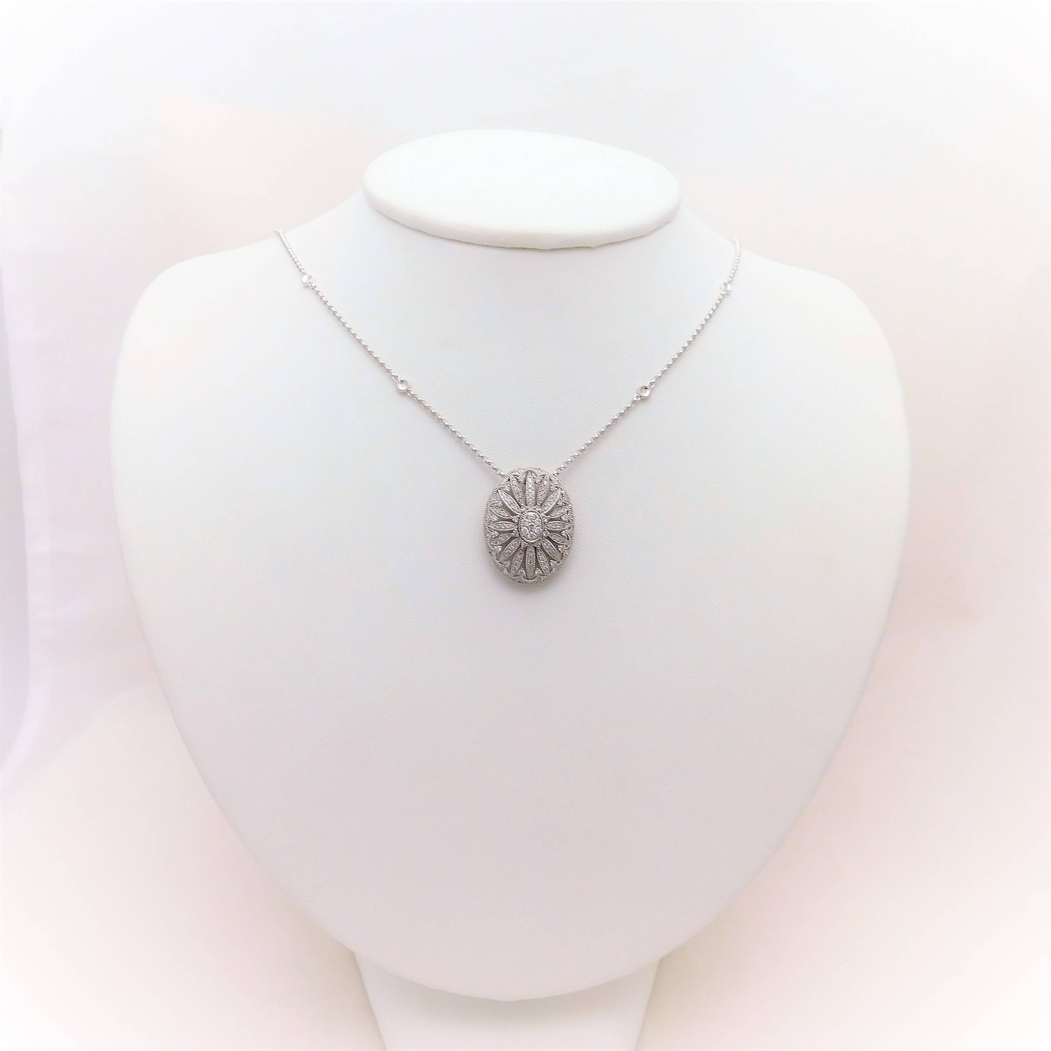 From a beautiful Southern estate.  One of the loveliest necklaces we have acquired in quite some time.  This miraculous oval shaped diamond cluster pendant necklace has been crafted in solid 14k white gold.  It is masterfully jeweled with 111 round