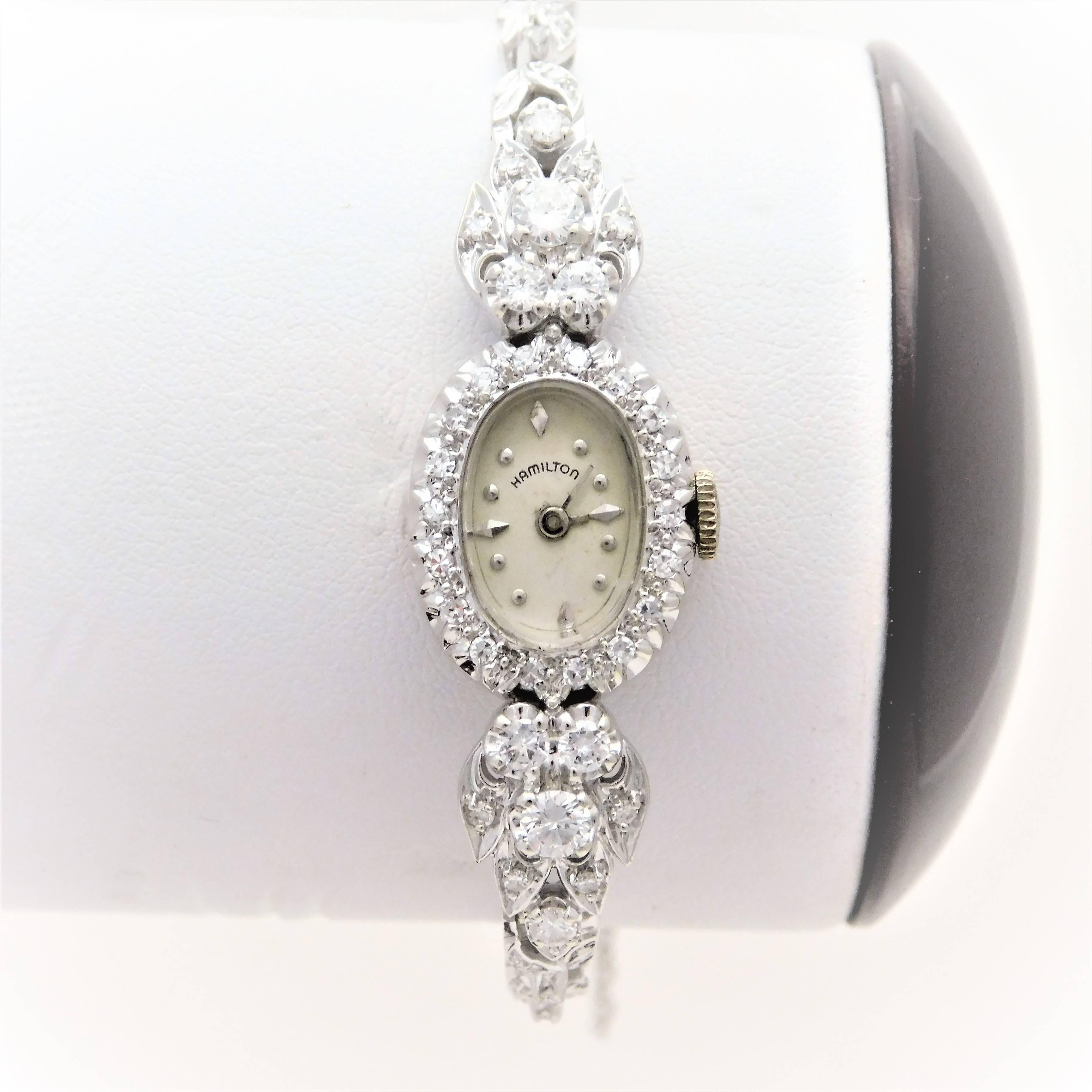From an elegant New Orleans estate.  Circa 1920.  This gorgeous art deco style Hamilton ladies’ luxury time piece has been crafted in solid 14k white gold.  The ornate diamond designs in the bezel and the band are breathtaking.  It is jeweled with