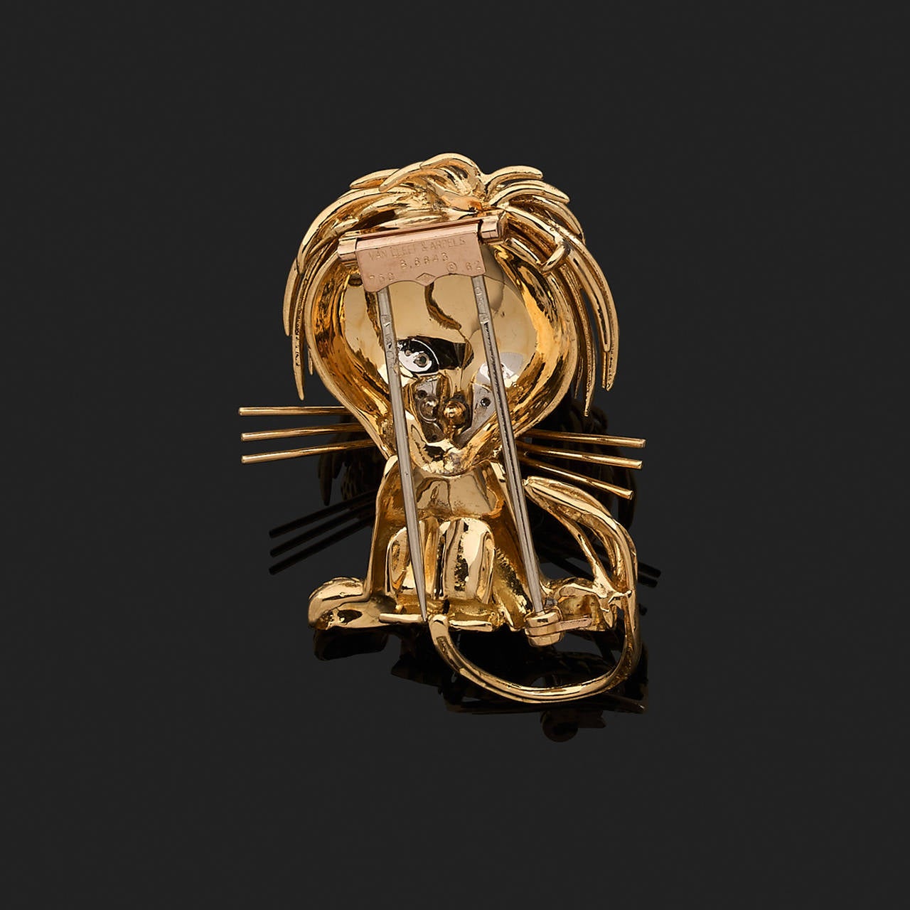 A diamond, emeralds, black enamel and 18k gold brooch stylizing a lion. Signed Van Cleef & Arpels and numbered B8843.