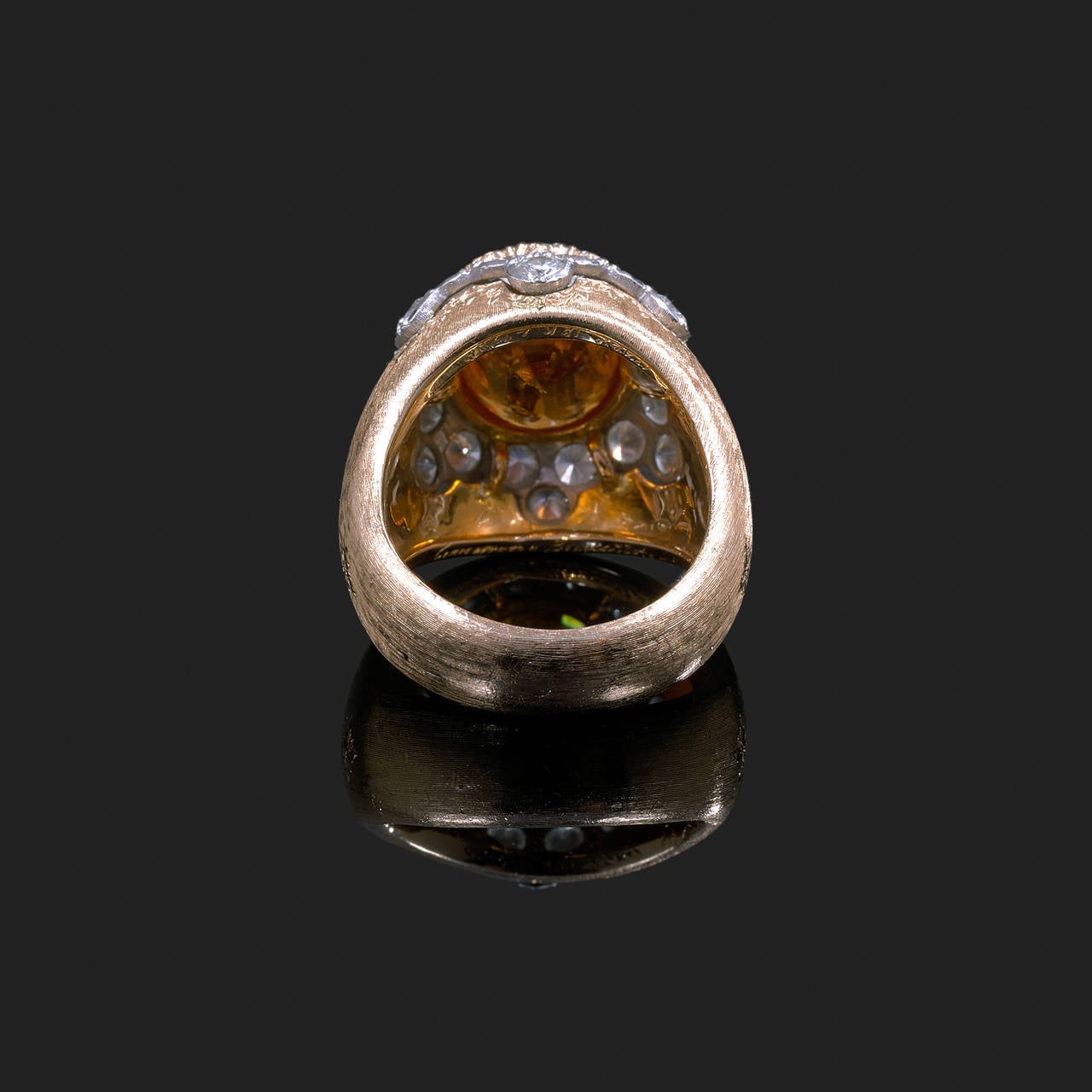 A diamonds, spessartite garnet and 18 k gold ring. Signed Mario Buccellati and numbered L4129.