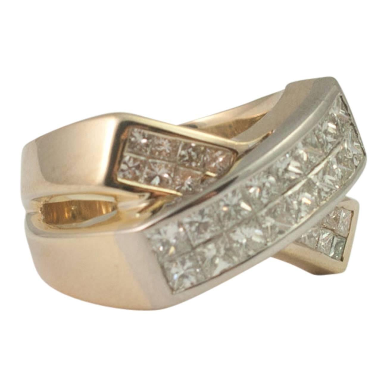 Princess cut diamond crossover ring; the ring is formed of two bands, each set with two rows of princess cut diamonds totalling 1.70ct.  The upper row is set in white gold, the lower row and the body of the ring are set in yellow gold.  Weight