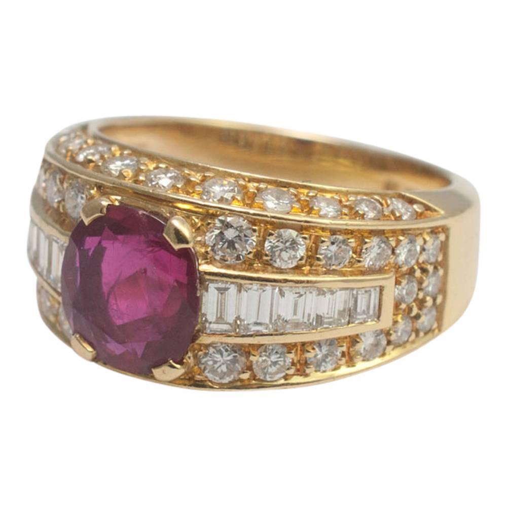 Ruby and diamond band ring by the exclusive Parisian jewellery house, Fred.  The ring is set with a central vibrant red ruby weighing 1.67ct and rows of brilliant and baguette cut diamonds weighing 1.11ct. Stamped FRED, Paris, 750.  This would make