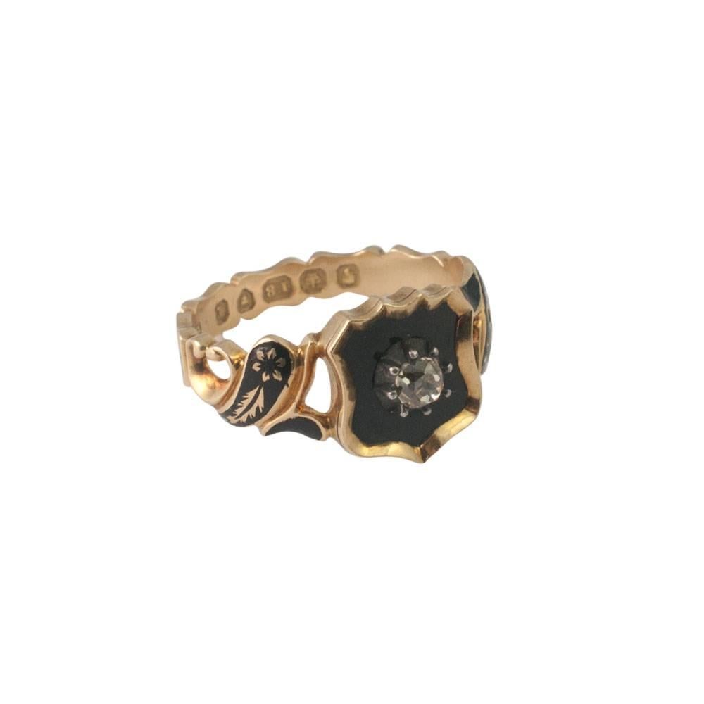 This lovely Victorian mourning ring dates from London 1846 and is set with a black enamel shield on the front with an Old Mine cut diamond in the centre.  The shoulders are scrolled on each side with black enamel and floral gold motifs.  The back of