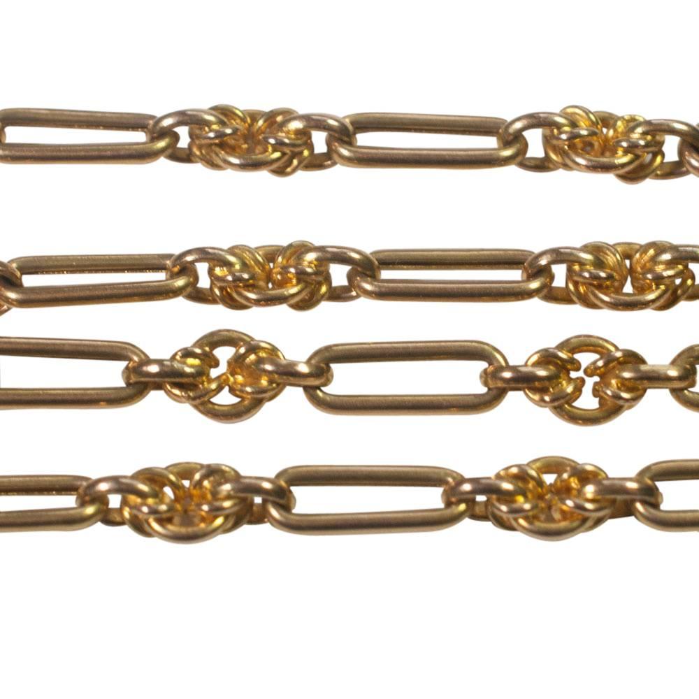 Long Victorian 15ct gold chain composed of oval links joined by intertwined round links and fastening with a solid bolt ring.  Weight 32.5gms; length   147cms (55