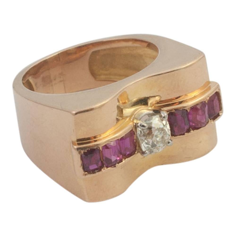 Mid century retro ring; this ring is a great example of a 1940s ring in a rich 18ct rose gold which compliments the colour of the natural rubies.  It is set with with an Old European cut diamond weighing 0.45ct.  It is probably French but has lost