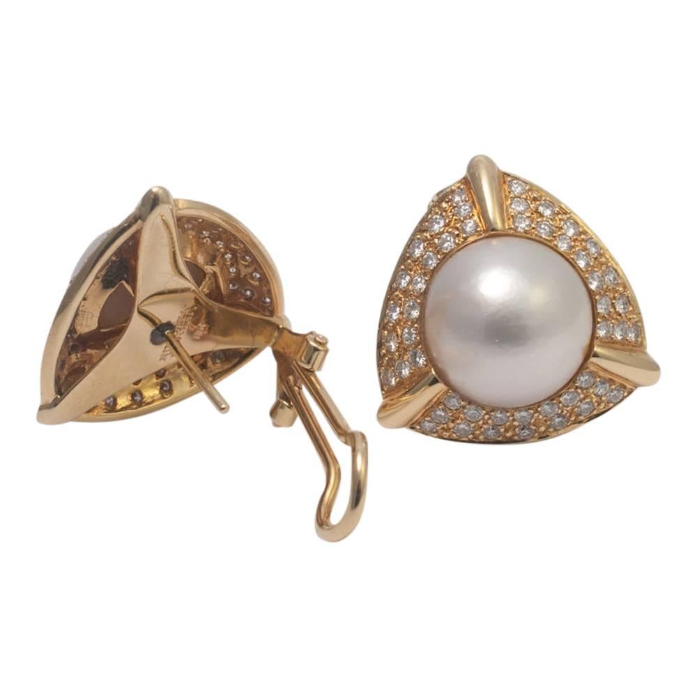 Gold and diamond earrings set with large Mabé pearls.  The earrings are in 3 sections forming a triangular design around a central Mabé pearl.  The brilliant cut diamonds weigh 2cts (approximately).  These big, bold earrings are fitted with a clip