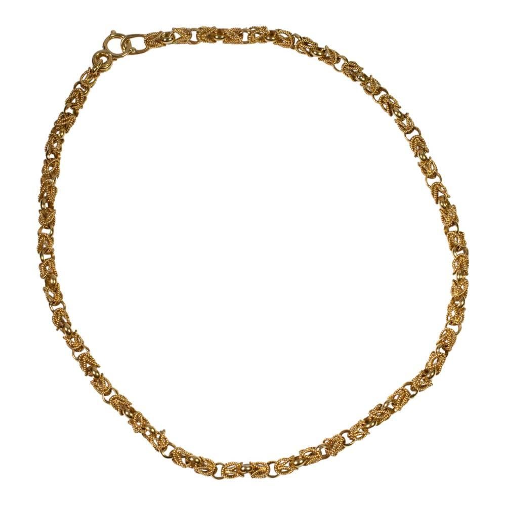 Heavy interlocking rope necklace in 18ct gold.  The clasp is formed of a "handcuff" which opens and closes and fits into a gold loop. Weight 49.2gms; length 45cms.  Stamped 18A and tested as 18ct gold. 
We also have the matching bracelet