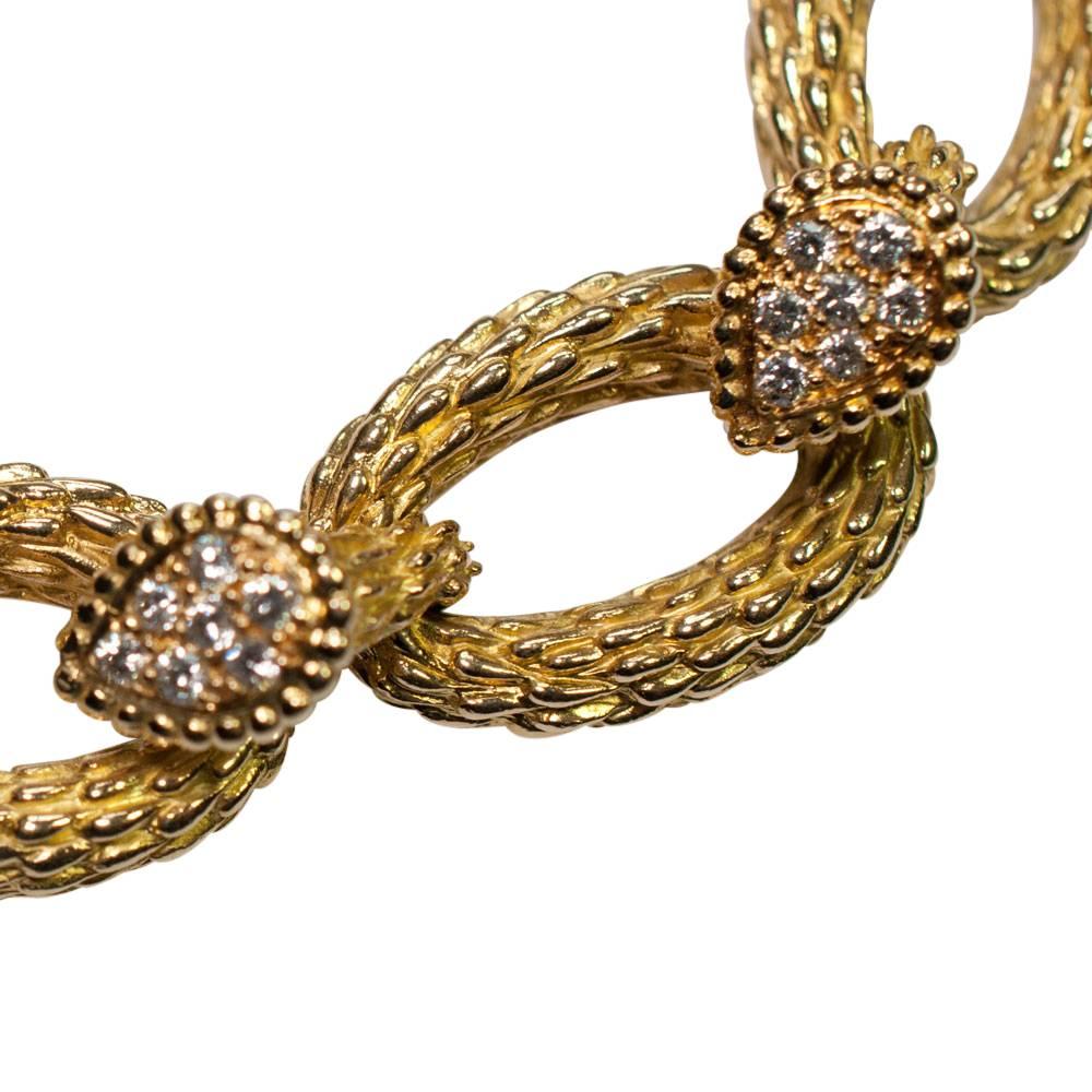 French 18ct textured gold and brilliant cut diamond bracelet; this is formed of oval links joined by smaller, diamond set links.  The diamonds weigh a total of 1.12ct; bracelet weight 46gms; length 18.5cm; width 1.5cm. Closes with an invisible clasp