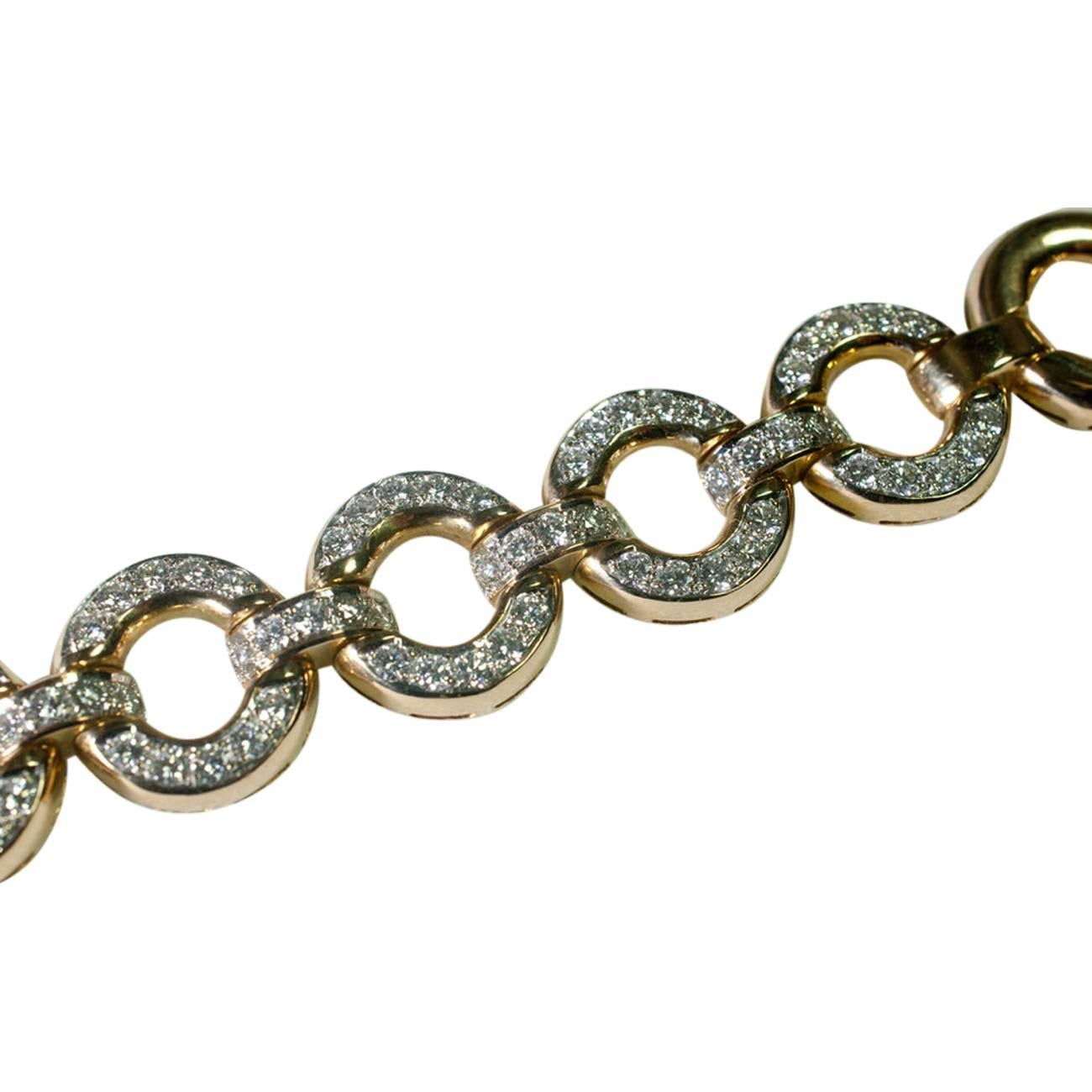 18ct gold bracelet consisting of 11 circles, 5 of which are set with brilliant cut diamonds totalling 6ct.  It is fitted with a strong clasp which clicks into the end section and has a figure-of-eight lock for added security.  Weight 56gms; length