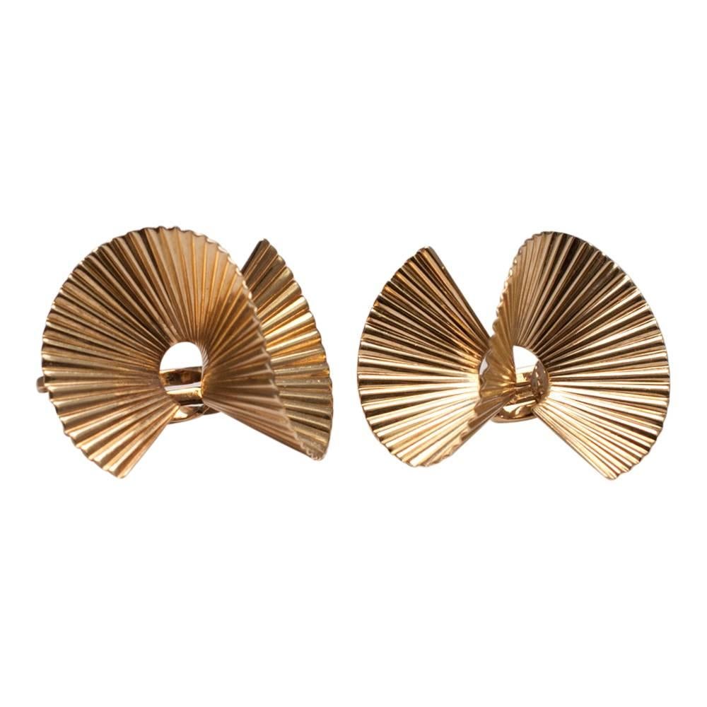 Tiffany & Co 14ct gold fluted wave clip on earrings for non-pierced ears; these stylish earrings are in the form of a wavy "S" shape.  Weight 12.2gms.  Signed TIFFANY & CO, 14kt, and numbered.  Fitted with a moving pad on the clip