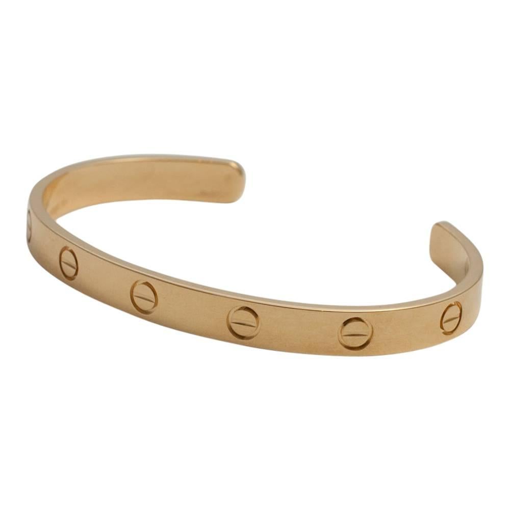 Cartier 18ct yellow gold open Love bangle; Size 17, signed Cartier, 750, numbered and stamped with the Swiss convention mark which guarantees its authenticity, made in Switzerland by Cartier.  This bangle has been re-polished.  Weight 23.5gms.