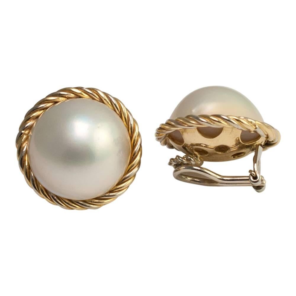 Large Mabé pearl and 18ct gold clip-on earrings for non-pierced ears.  The pearls have a good lustre and are set into in a gold ropework design mount.  They are fitted with a solid clip which is in excellent working order.  Stamped 750 (18ct);