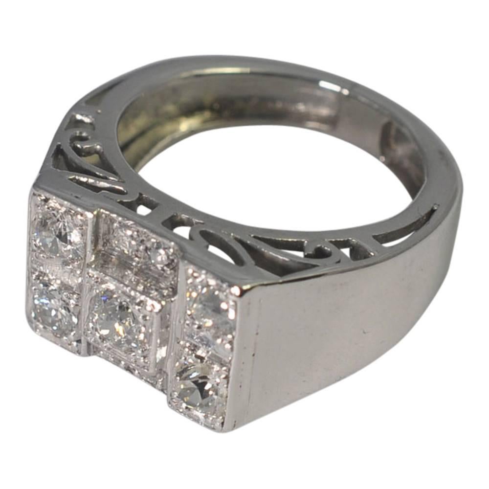 Chunky Art Deco ring set with 0.75ct of Old European Cut diamonds; the mount has Art Deco carving at the top and bottom which is visible when the ring is being worn.  Weight 8.9gms..  Tested as 18ct gold.  Finger size M (UK), 6.5 (US), 53 (EU) which