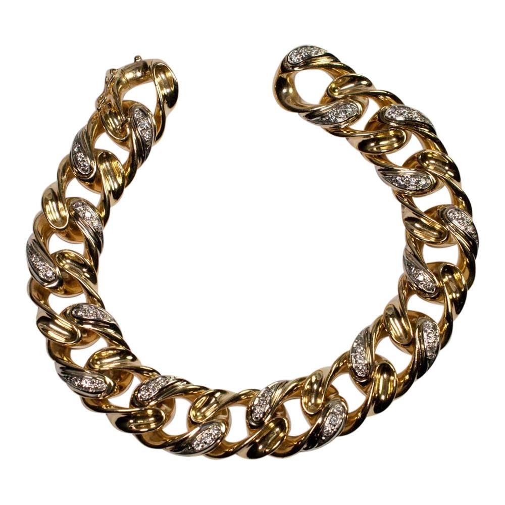 Heavy 18ct gold and diamond curb link bracelet by Tiffany & Co;  the links are alternatively gold and diamond set, each diamond link having 3 8-cut diamonds weighing a total 1.10ct. The bracelet opens and closes by the end link which opens and locks