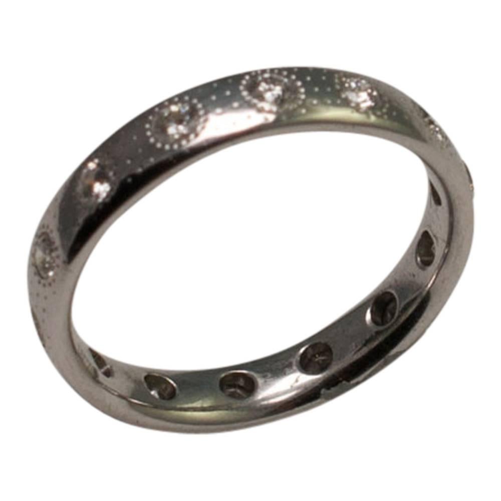 Unusual De Beers brilliant cut diamond eternity ring; the total diamond weight is 0.40ct and the ring is decorated in a patterned dots design. Width 3.6mm; depth 1.6mm.  Weight 3.4gms.  Finger size L (UK), 6 (US), 51.5 (EU).  This ring is in