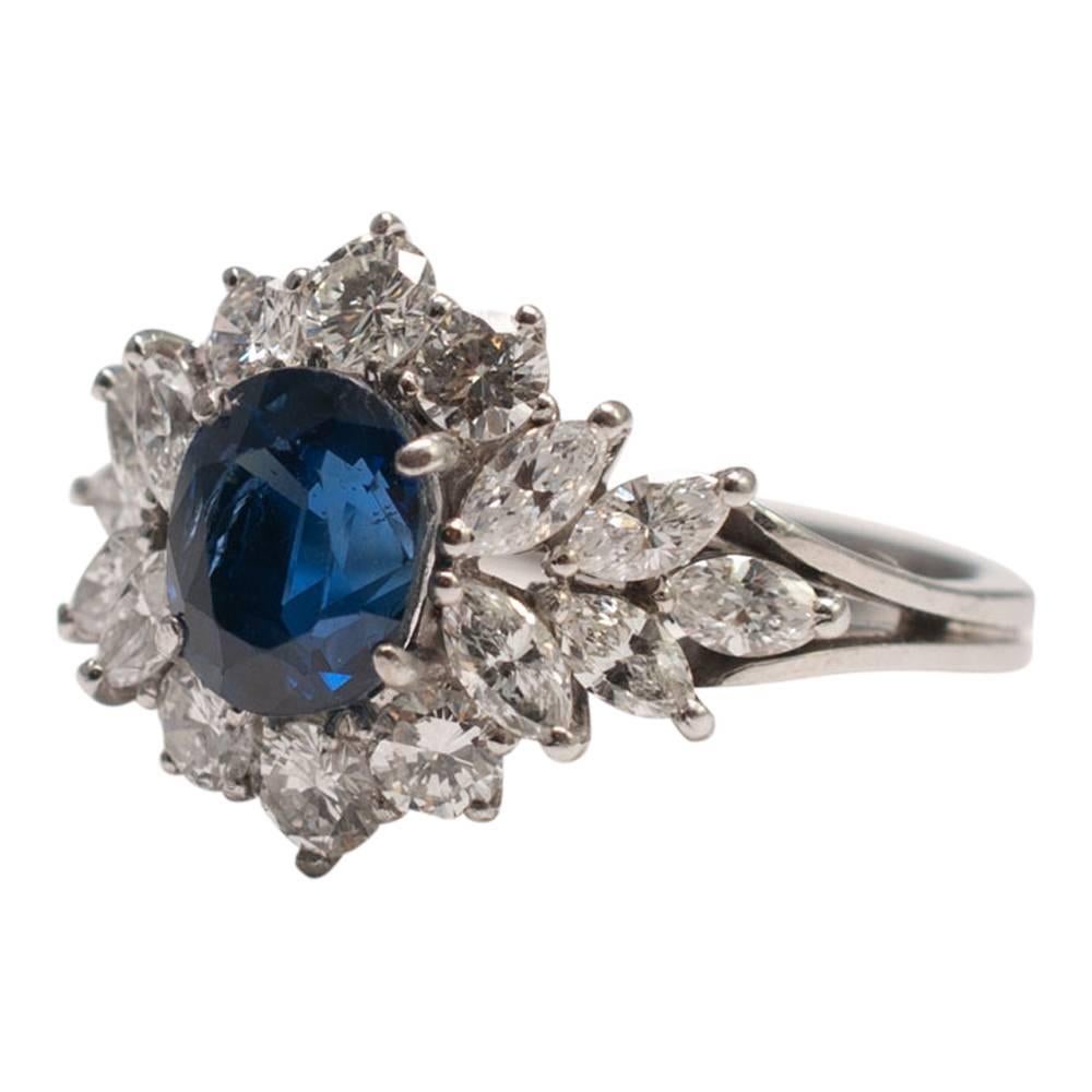 Glamorous midnight blue sapphire ring set with marquise and brilliant cut diamonds in 18ct white gold; a lovely item of decorative jewellery, perfect for a special occasion.  Mounted on a wirework basket and double shank, the sapphire weighs 2ct,