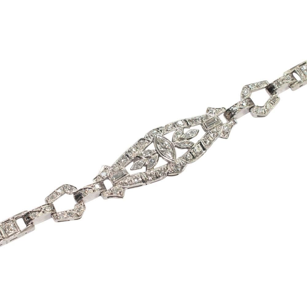 Pretty 1930s diamond evening line bracelet composed of an elegant central section set with marquise, baguette and 8-cut diamonds.  It is connected by diamond set hinged loops to the box link Old European and Transitional cut diamonds.  Total diamond