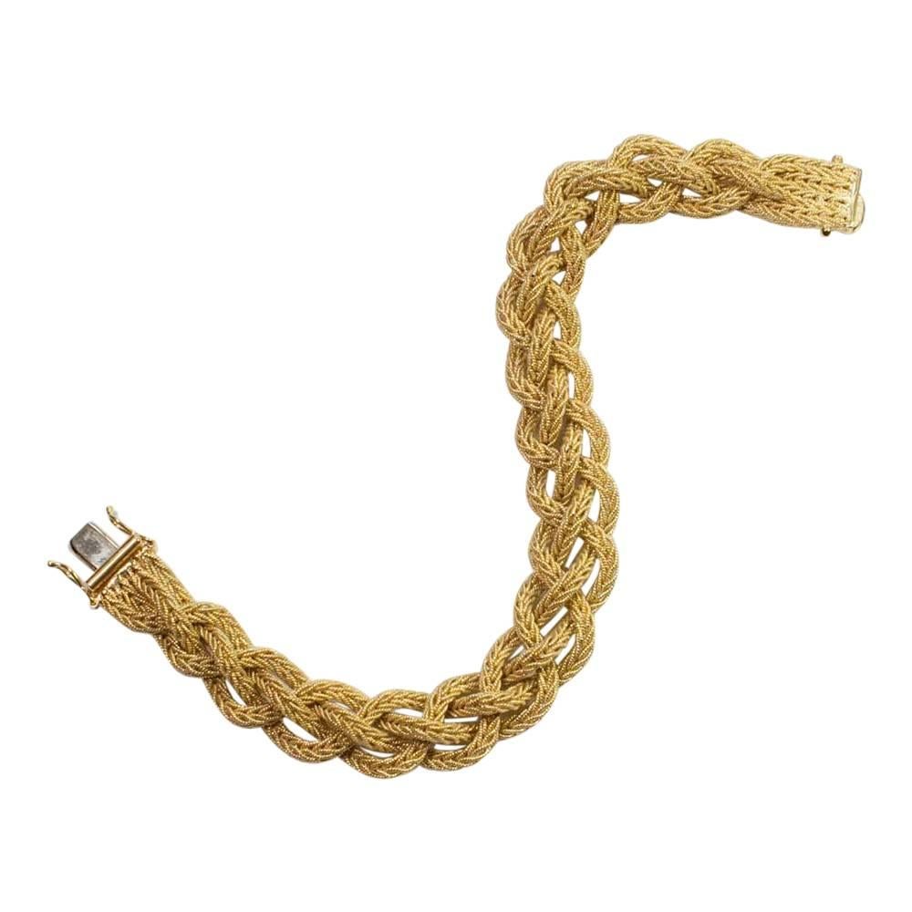 Heavy 18ct gold vintage Italian bracelet in a woven mesh design.  Each strand is woven within itself creating a beautiful plaited effect.  The bracelet weighs 43.1gms and closes with a click lock with 2 
