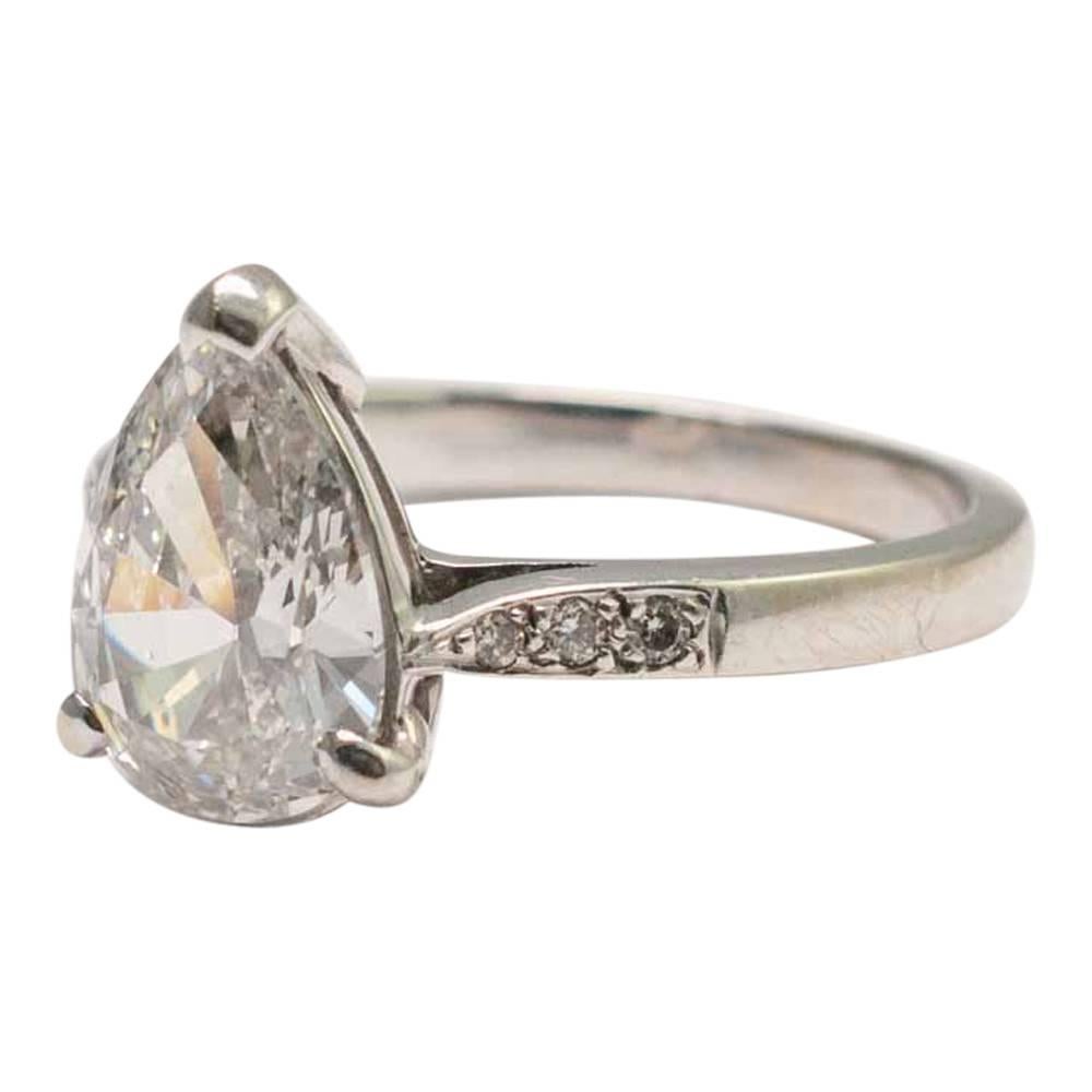 Beautiful 2.07ct pear shaped diamond solitaire ring; the diamond is certificated as F colour, VVS1 clarity.  It is mounted with three claws and three small diamonds set into the shoulders on each side and set in 18ct gold.  Stamped 750.  Finger size