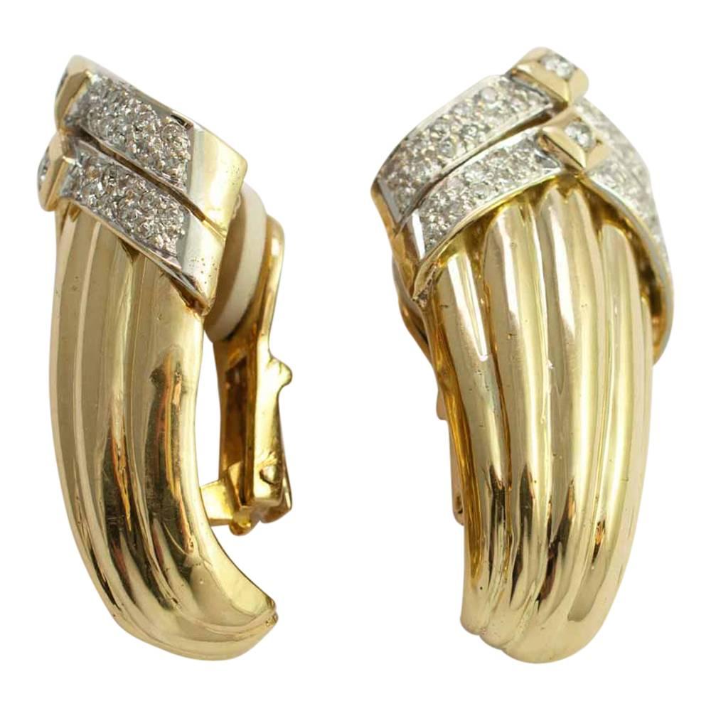 Dramatic, large, 18ct gold and diamond clip-on earrings.  These are in a ribbed gold design with diamond set chevrons at the top.  The brilliant cut diamonds weigh 1ct.  The earrings are for non-pierced ears and are fixed with a strong gold clip. 