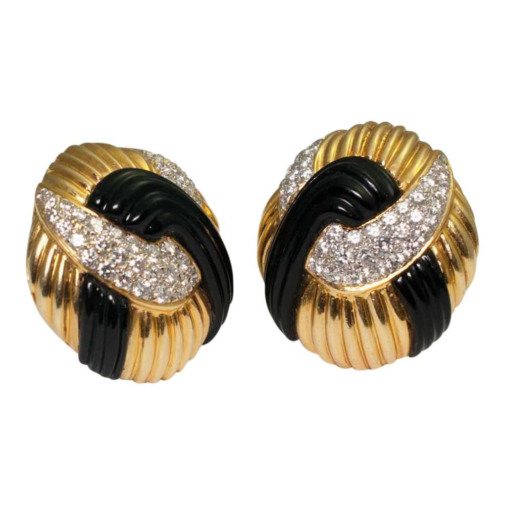 Stylish and smart, onyx diamond and gold earrings; these are very eye-catching and would add glamour to an evening outfit.  They are set with brilliant cut diamonds weighing 1.50ct interlinked with reeded onyx and fixed with a clip and post for