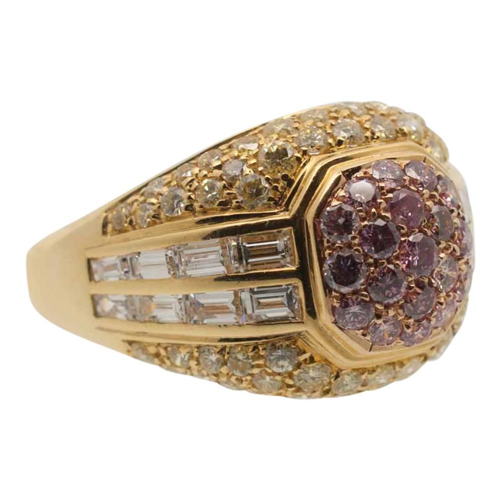 Dramatic statement bombé ring set with pink; yellow and white diamonds totalling 3cts. The central top section is pavé set with pink diamonds, the middle section has two rows of white baguette diamonds and the top and bottom outer edges are pavé set