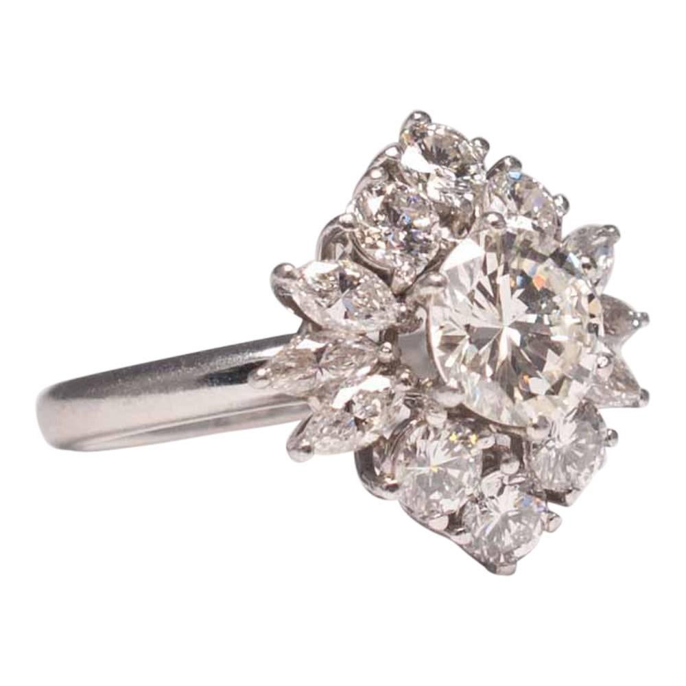 Dramatic diamond cluster ring; this beauty makes a real statement and is set with a central brilliant cut diamond weighing 1.40ct which is surrounded by brilliant cut and marquise diamonds totalling 1.60ct.  The ring is mounted in platinum on a