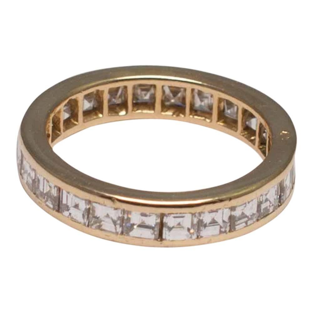 Super stylish French square cut diamond eternity ring mounted in 18ct yellow gold, by Parisian jewellery house O.J. Perrin; the square cut diamonds are channel set and weigh a total of 2.40cts.  Weight 3.9gms; depth 4mm; maker's mark OJP and stamped