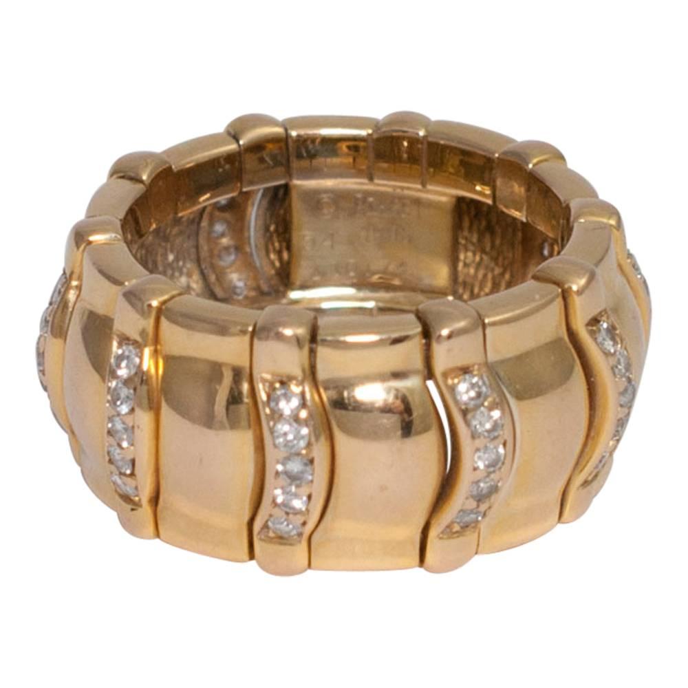 Piaget gold and diamond articulated ring.  This intricately made ring is in curved sections with the brilliant cut diamond sections moving slightly and would make a wonderful wedding ring.  Total diamond weight 0.50cts.  Stamped PIAGET 1993,