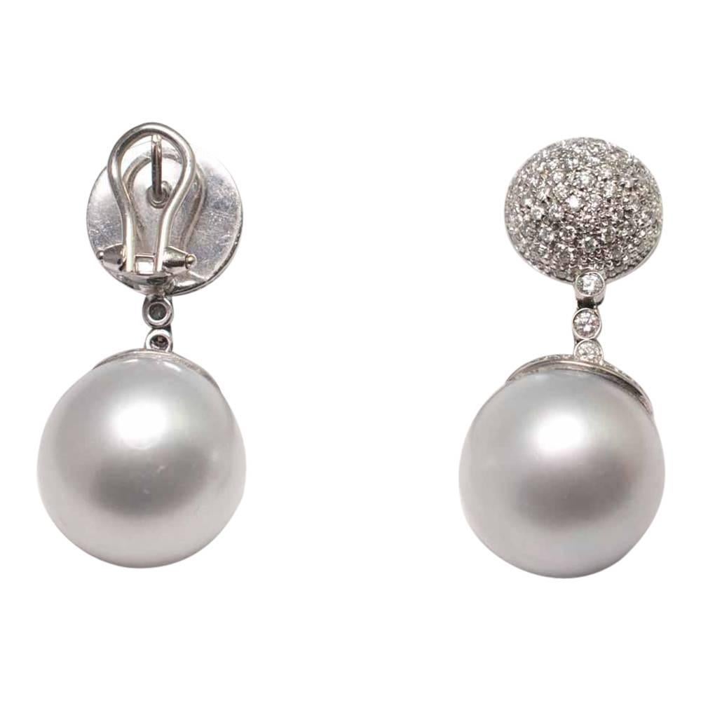 Huge South Sea pearl and diamond earrings; these dramatic earrings are set with large silvery white South Sea pearls measuring 17.3mm and pavé set diamonds totalling 4.50ct.  The pearls are fixed to a diamond set cap which in turn is suspended from