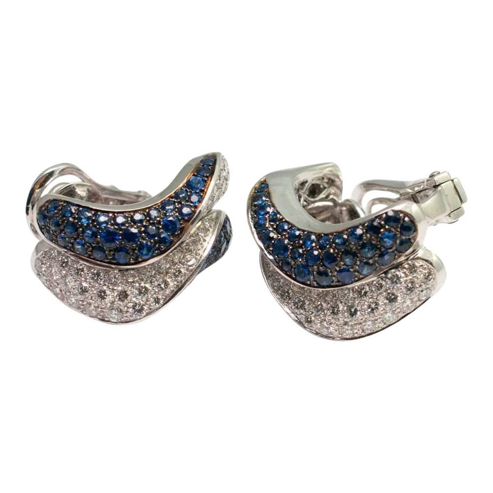 Sapphire and diamond double row wave earrings by Adler; these dramatic earrings are pave set with sapphires weighing 4.80ct and brilliant cut diamonds weighing 2.40ct. They are cleverly made with a folding post so can be worn with either pierced or
