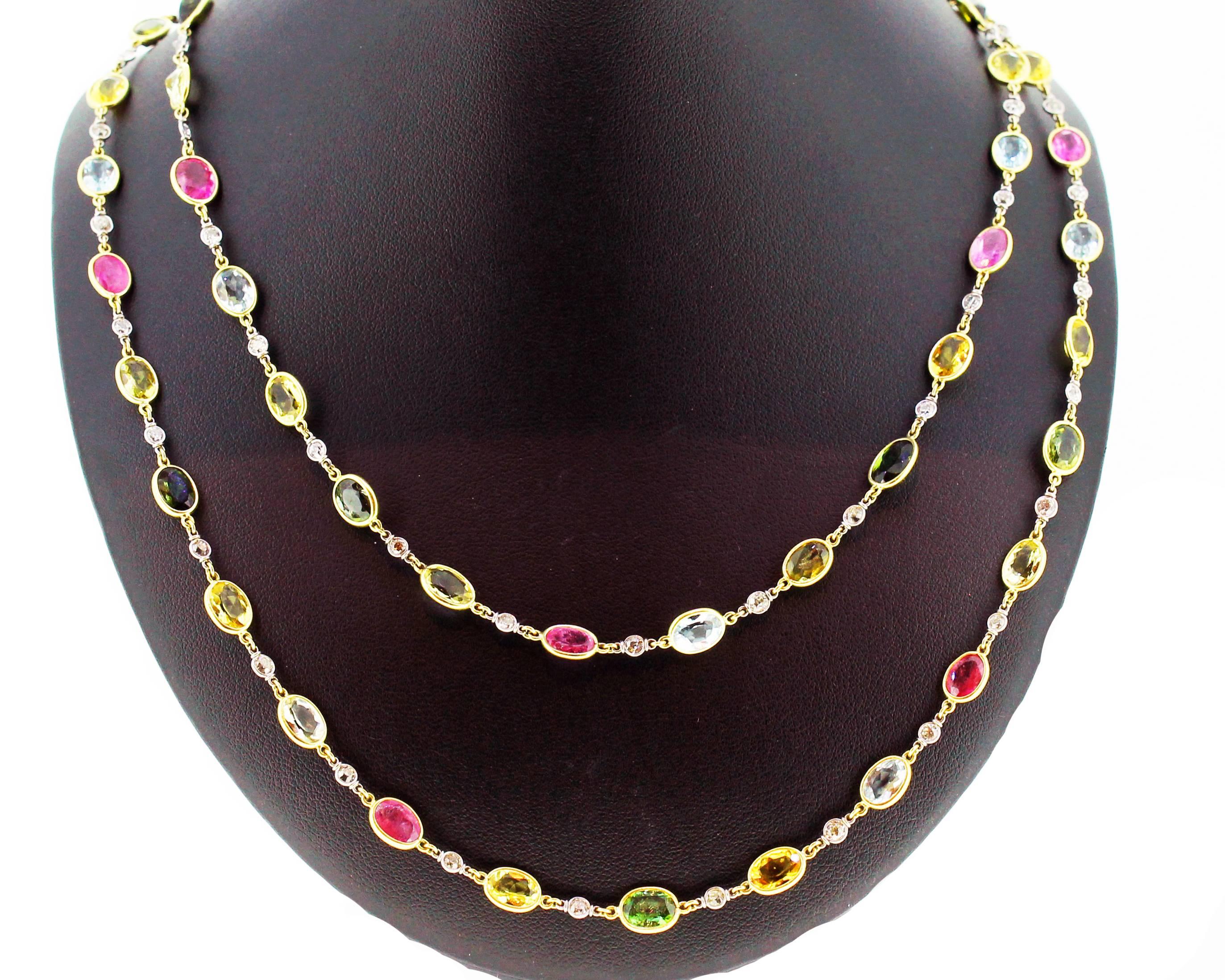 Multi colour sapphire and diamond 'Spectacle set' long chain mounted in 18ct gold. Each collet set coloured oval sapphire set between round diamond spacers. 
Total diamond weight 4cts. 
Total sapphire weight 54cts.
