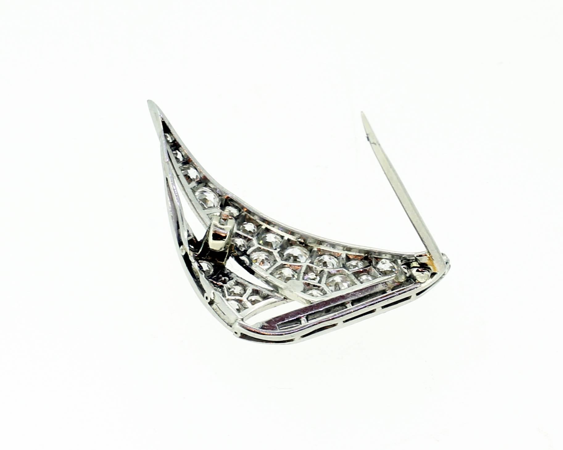 Art Deco diamond set Sailing ship brooch mounted in platinum. French. Circa 1920. The ships hull set with baguette cut diamonds and the sails pave set with round diamonds. Total diamond weight 0.70cts. Measuring 2.2cm wide by 3cm high