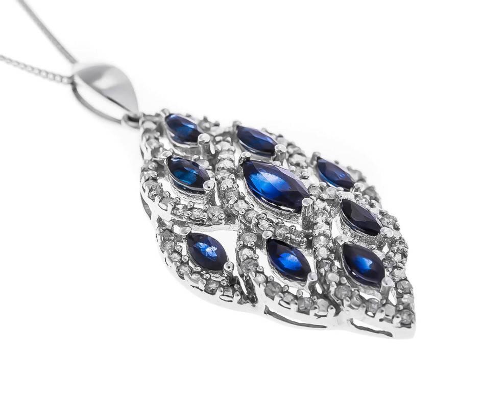 This striking and opulent pendant is fashioned in 9ct white gold and encrusted with deep blue marquise cut sapphires and brilliant cut diamonds. This beautiful piece comes complete with a white gold chain and will make a wonderful gift for a