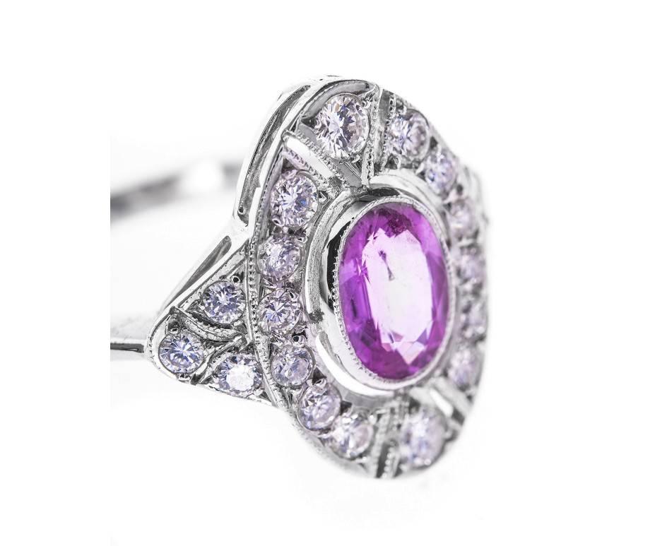 A dress ring with a bright pink sapphire surrounded by pave set diamonds (totalling 0.53ct approx.). Beautiful open work design keeps this ring light and wearable. For lady who loves to look pretty in pink.