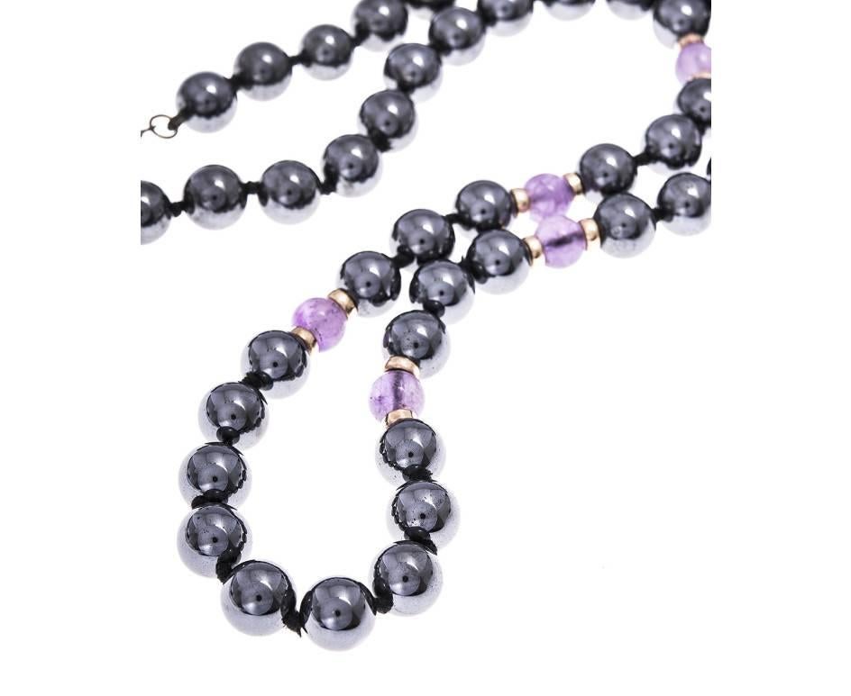 A beautiful beaded necklace of shiny black metallic haematite delicious purple amethysts. The amethyst beads are scattered throughout and with a gold plated bead on either side. A gorgeous gift of tactile and colourful gems.