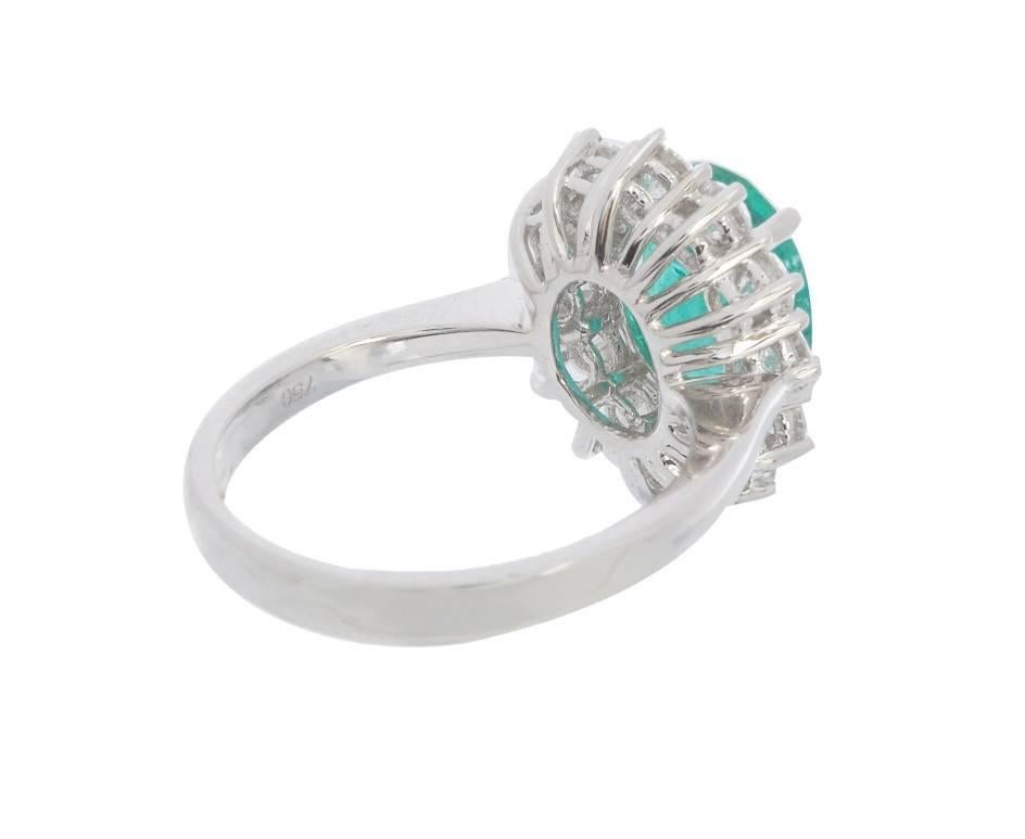 A fantastic example of traditional jewellery at it's finest. A bluish-green emerald weighing 2.68ct is surrounded by twelve scintillating round brilliant cut diamonds weighing 1.29ct. A classic design in 18ct white gold, perfect for celebrating 35